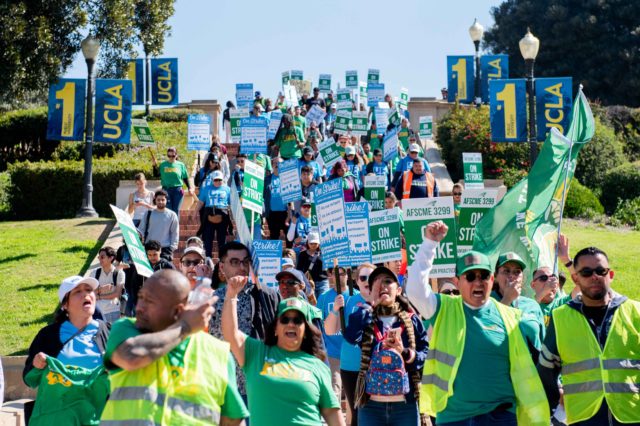Members of the American Federation of State, County and Municipal and County Employees Local 3299 and the University Professional and Technical Employees-Communications Workers of America 9119 strike on campus. A federal judge barred the Trump administration from freezing the UC’s federal funding Friday in a lawsuit brought by AFSCME Local 3299, UPTE-CWA 9199 and several other UC unions and faculty associations. (Andrew Ramiro Diaz/Photo editor)