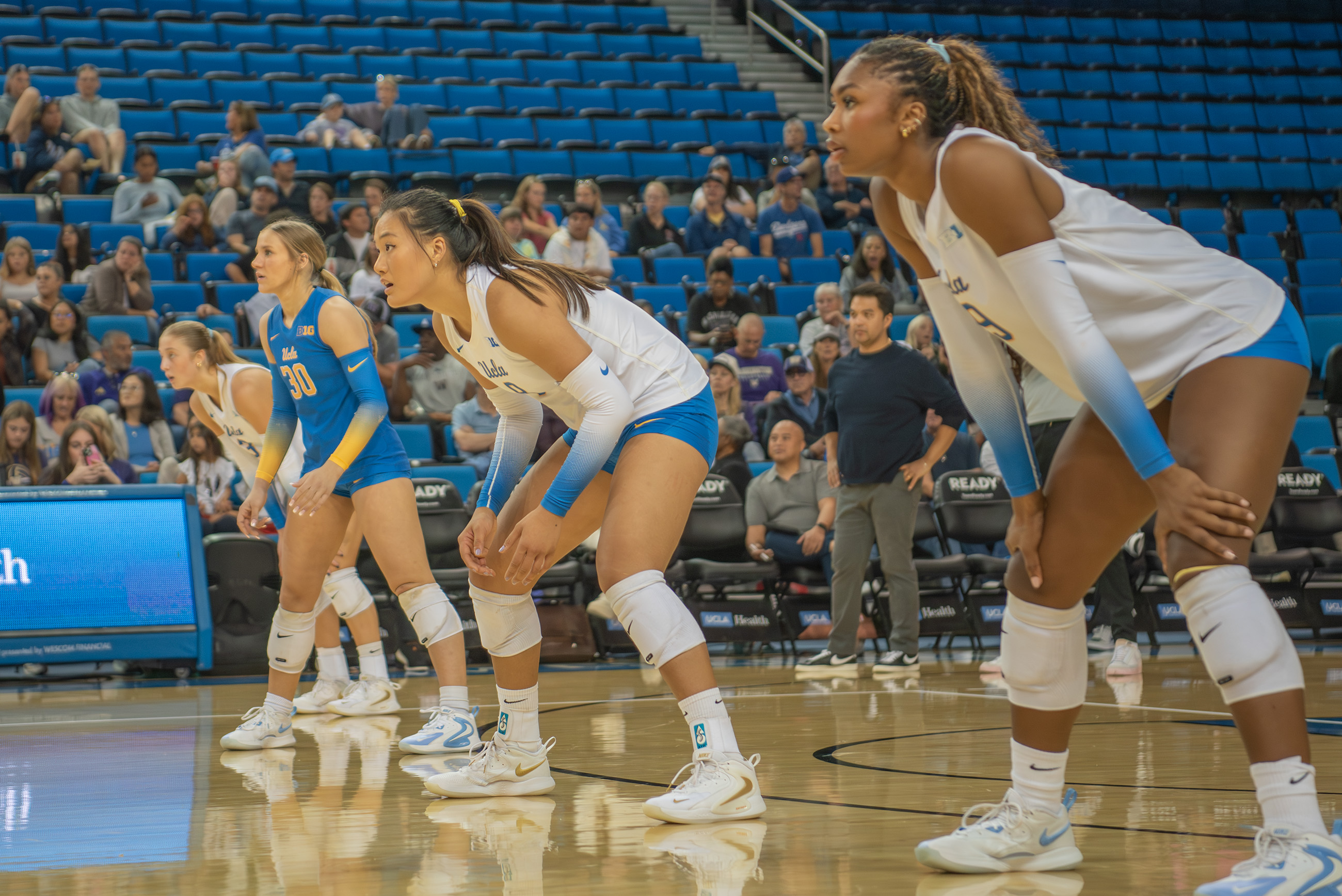 Schumacher (left), Li (middle) and Leverette (right) stand ready in serve receive. (Amanda Velasco/Daily Bruin senior staff)