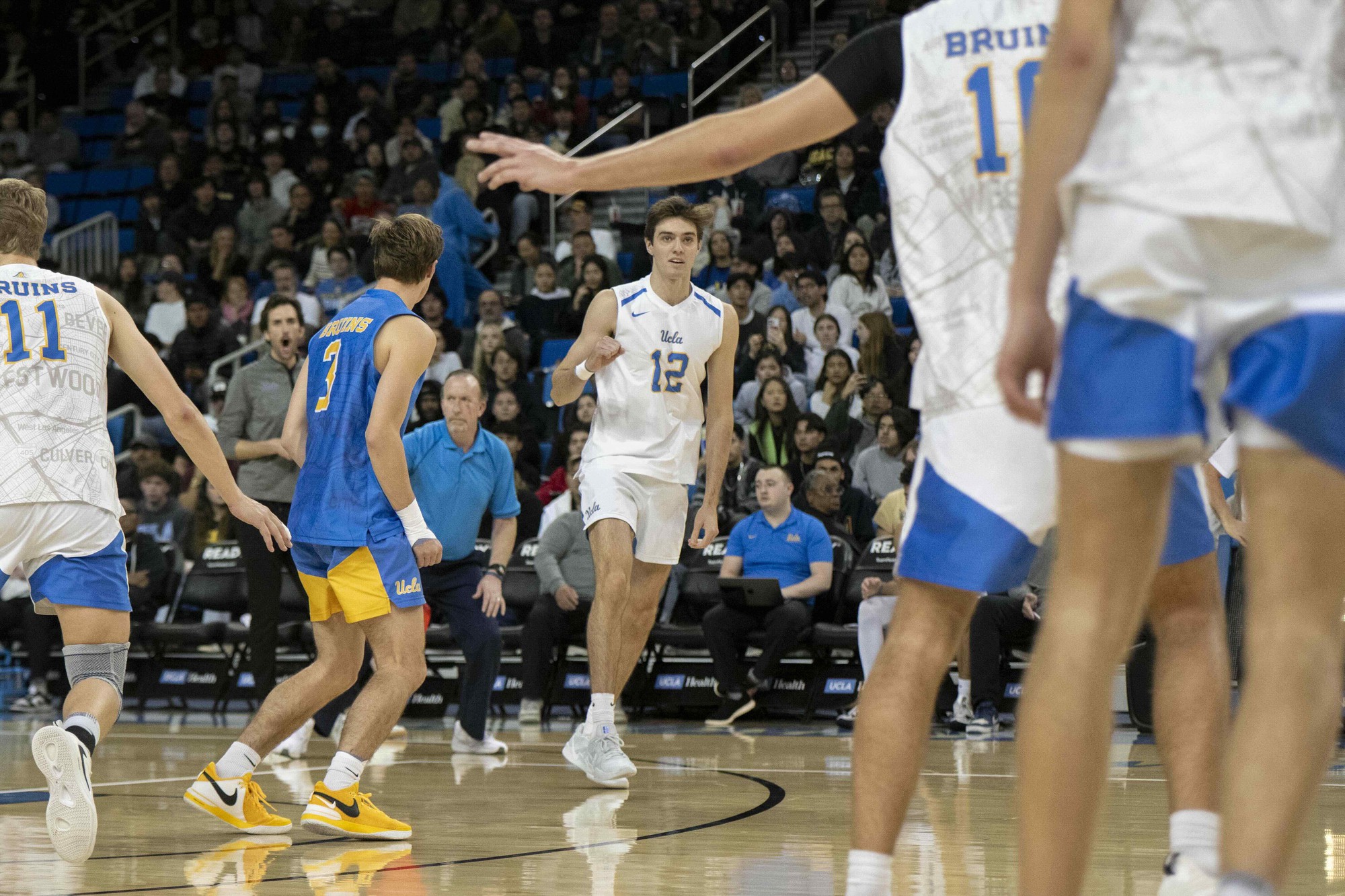 Sophomore outside hitter Sean Kelly raises his fist during a match.