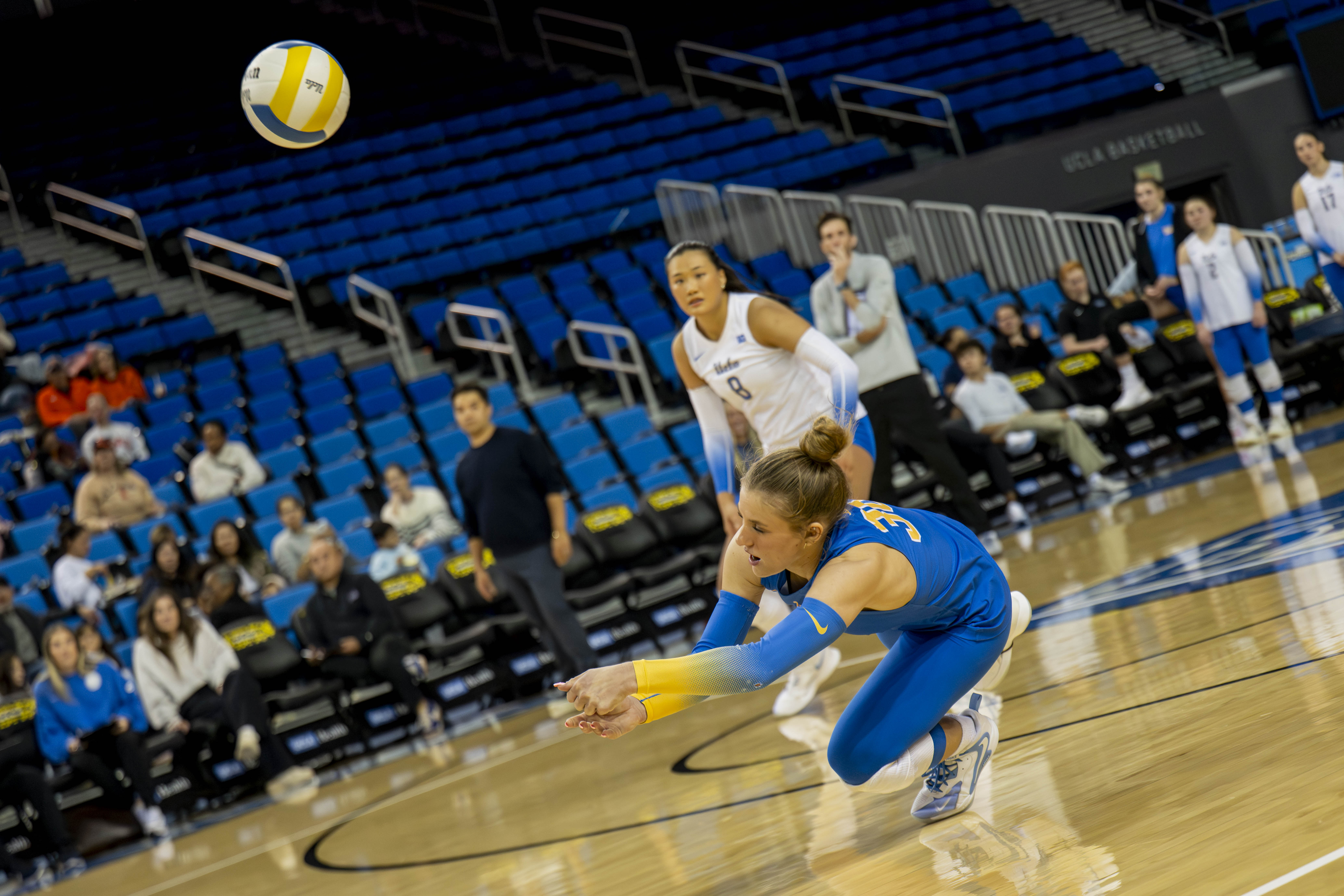 Sophomore libero Lola Schumacher begins to dive after digging a ball. (Vanessa Man/Daily Bruin)