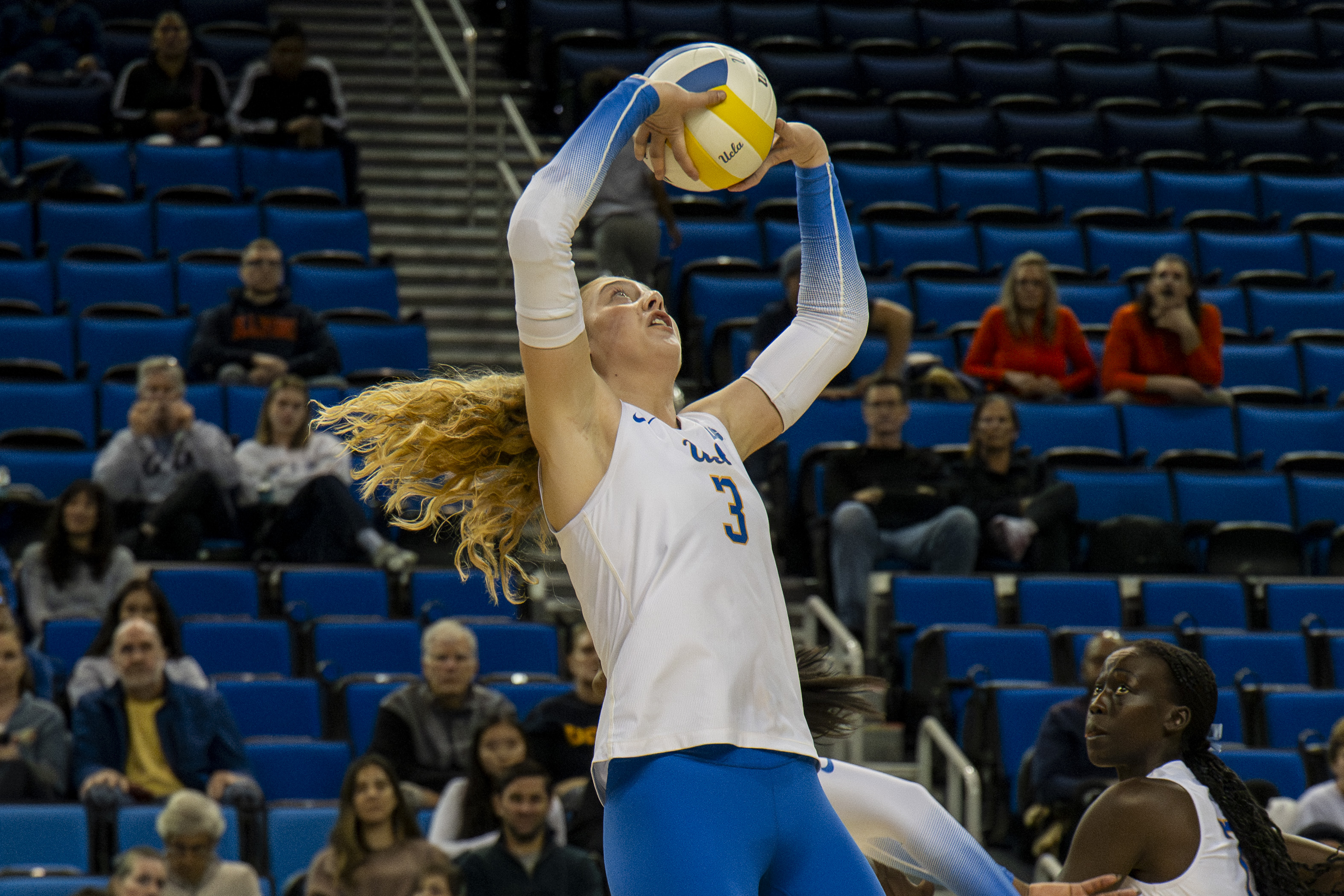 Sophomore setter Kate Duffey jumps and begins to back set the ball. (Vanessa Man/Daily Bruin)