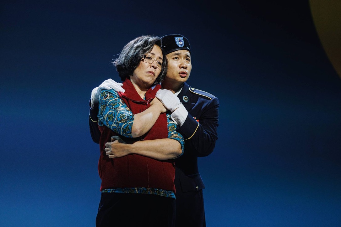Vu (right) as Danny Chen embraces Nina Yoshida Nelsen (left), who portrays Mother Chen. "An American Soldier" tells the story of Danny Chen, an Asian American soldier, and his experience in the army. (Courtesy of Marc J. Franklin and Brian Vu)