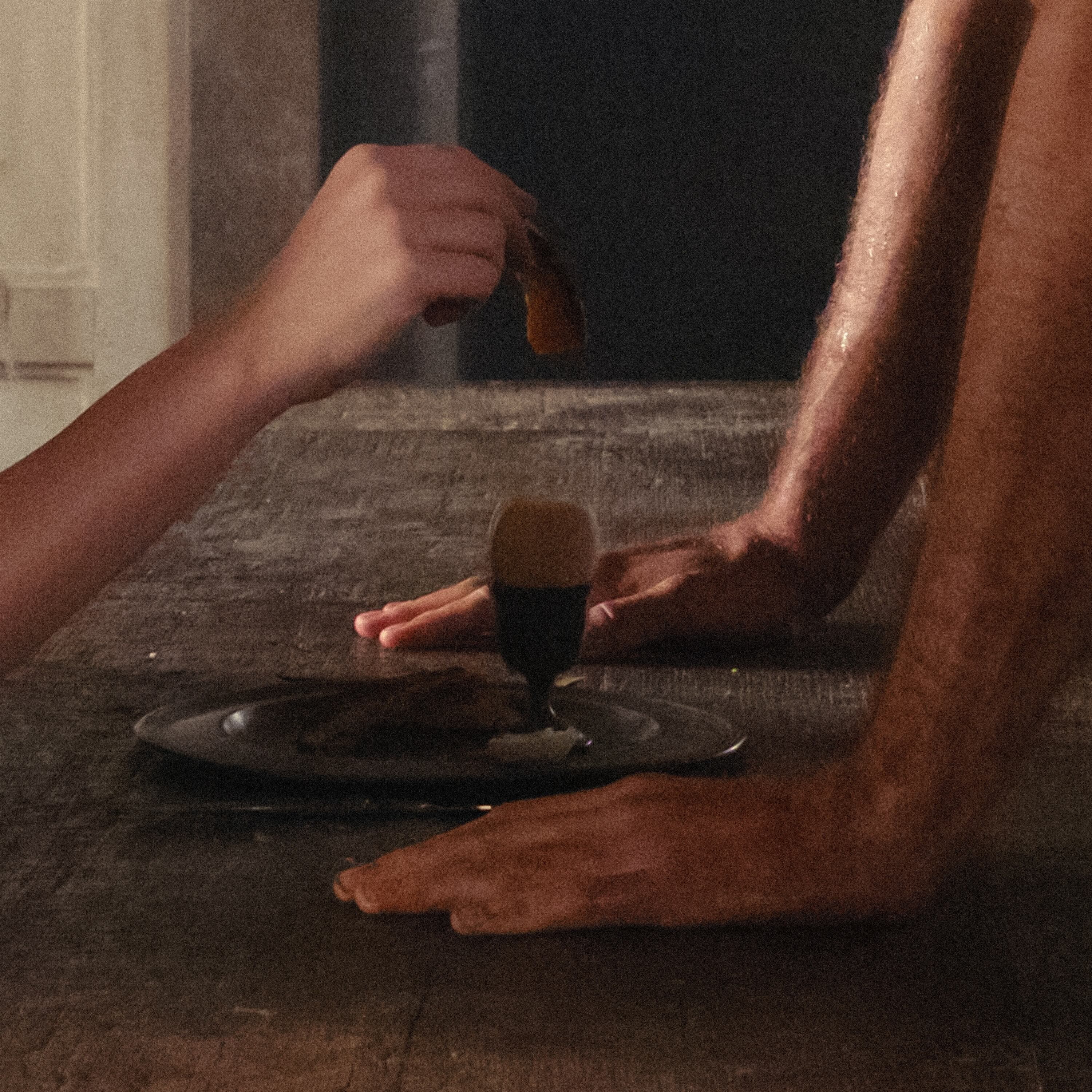 The cover of Charli xcx&squot;s upcoming release "Wuthering Heights" features a painting-like image of a wooden table with two hands against the surface, facing another hand. The album was heavily inspired by Emerald Fennell’s adaptation of Emily Brontë’s classic novel of the same name. (Courtesy of Charli XCX, Inc., under exclusive license to Atlantic Recording Corporation)