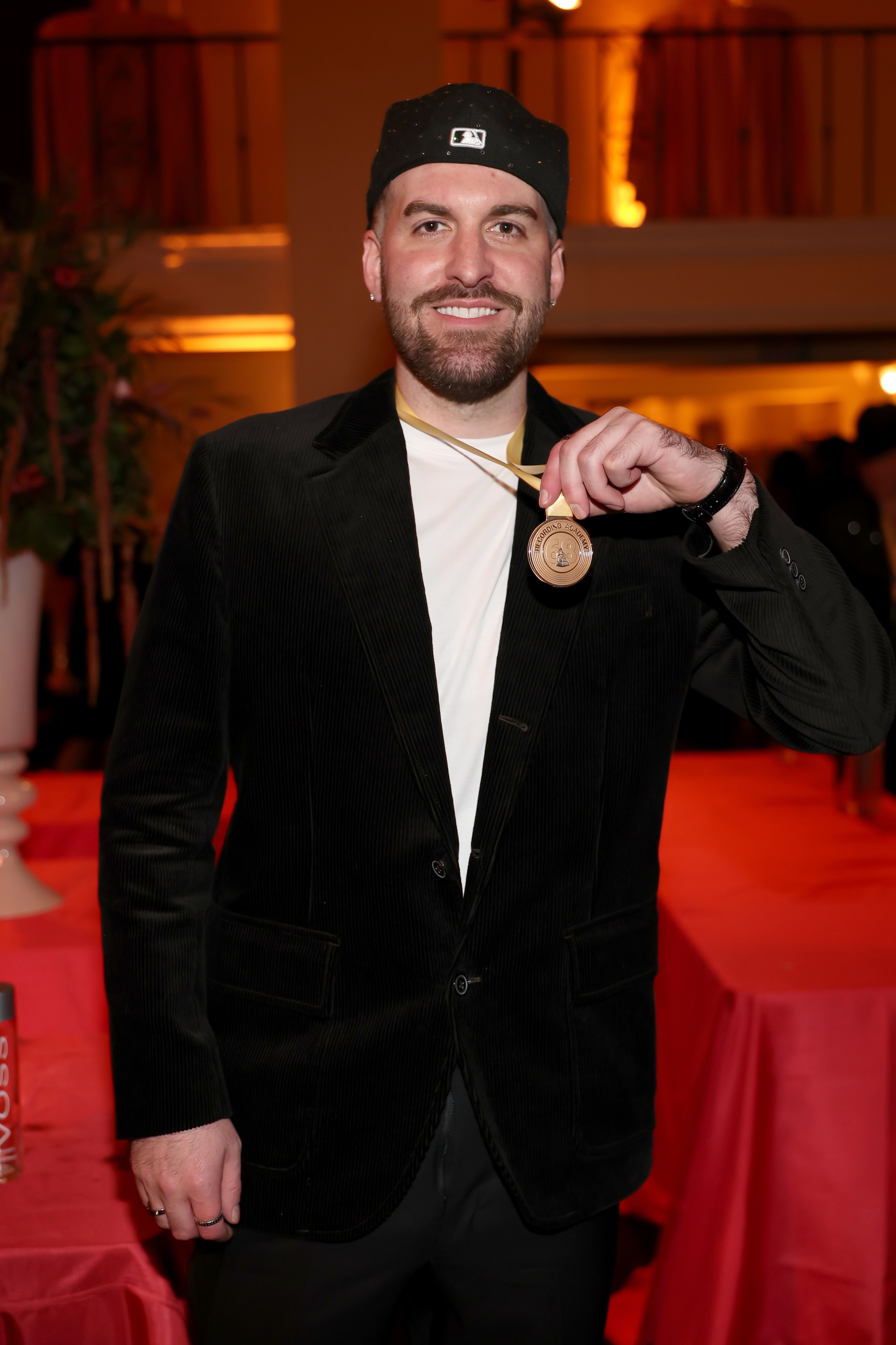 Sean Momberger wears a black suit and holds a gold medal. The producer and co-writer for the Best Rap Song winner, "tv off" by Kendrick Lamar, said he is particularly proud of the sampling used for the track. (Courtesy of Matt Winkelmeyer/Getty Images for The Recording Academy)