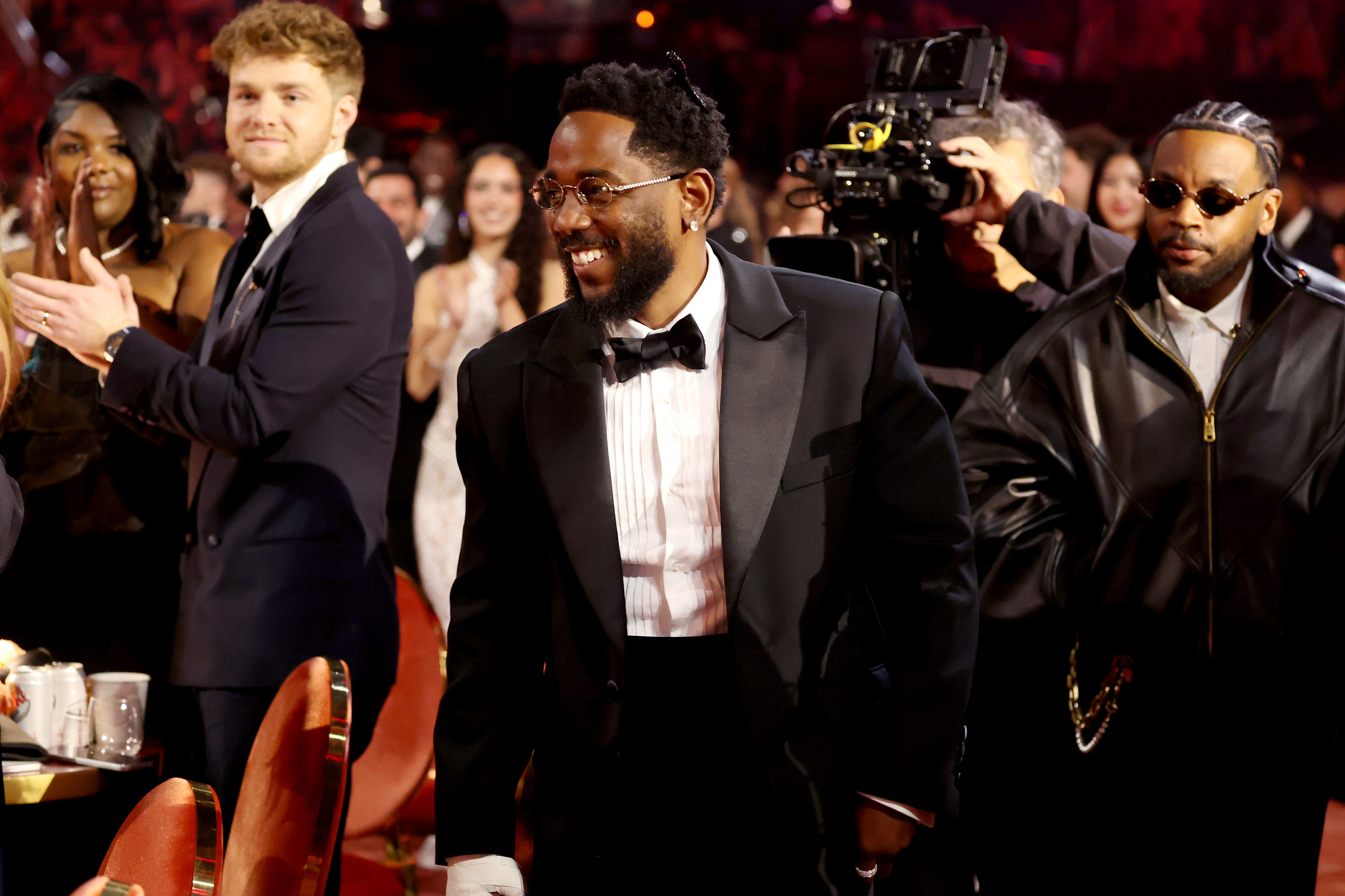 Pictured is Kendrick Lamar standing to go to the stage after one of his wins of the night. Lamar was the most nominated artist of the 2026 Grammys, with nine nominations, of which he won five. (Courtesy of Kevin Mazur/Getty Images for The Recording Academy)
