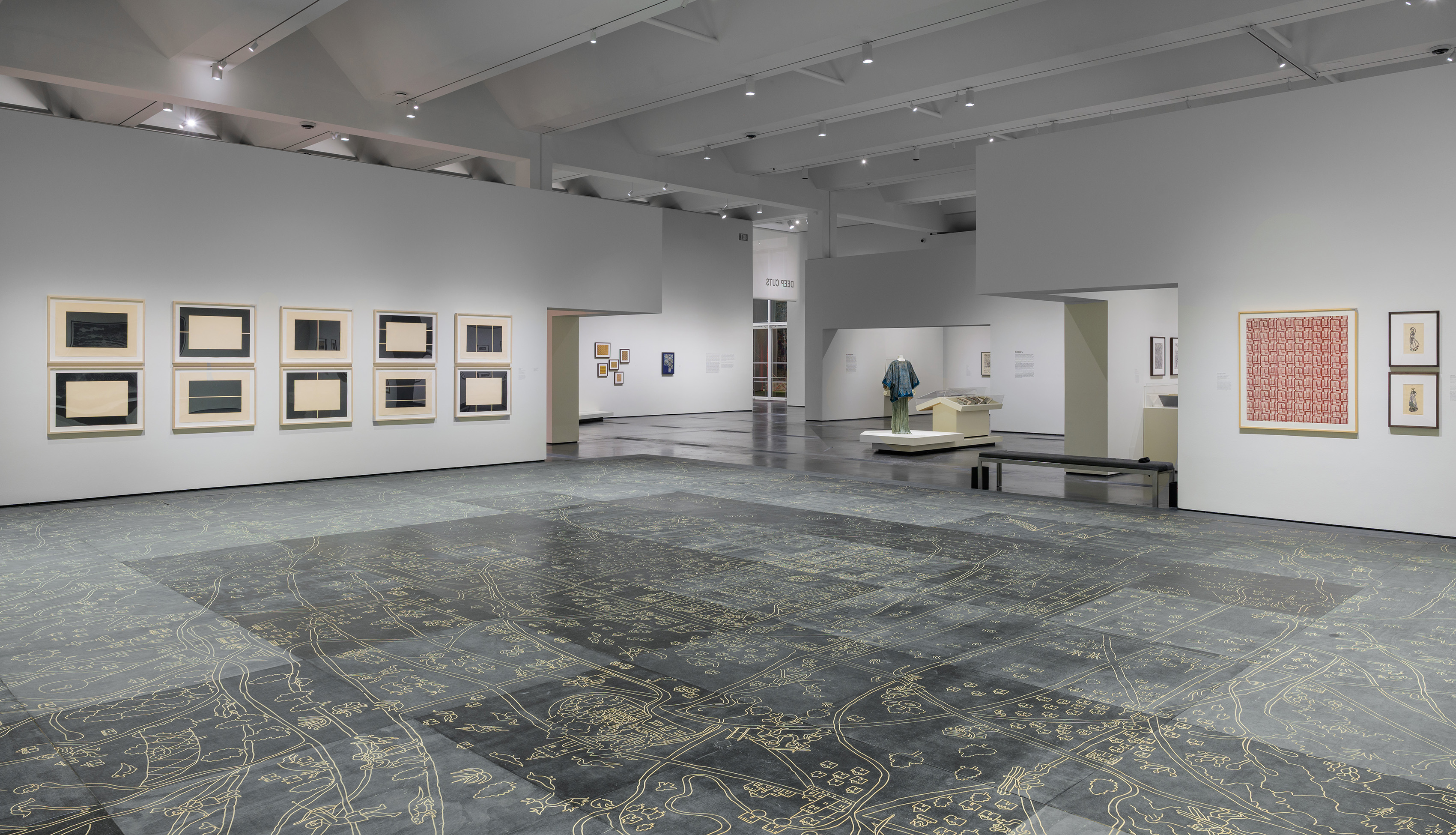 Pictured is the installation for Deep Cuts: Block Printing Across Cultures. Featuring Mariana Castillo Deball's “Vista de Ojos” as the installation floor, the exhibition explores block printing, one of the oldest surviving methods of mass image reproduction. (Courtesy of Museum Associates/LACMA, by Jonathan Urban)
