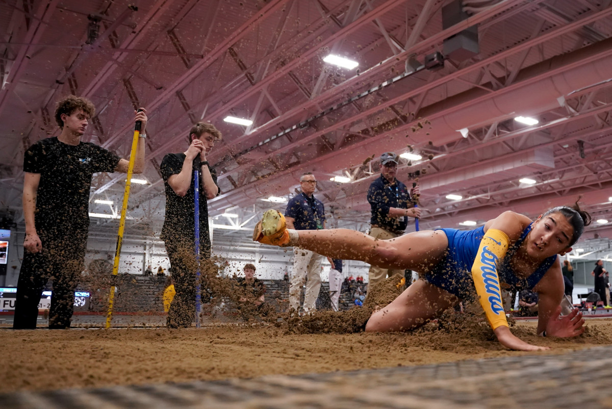 Graduate student multis athlete Sydney Johnson falls to the sand as she completes her jump. Johnson earned Second Team All-American selections in the heptathlon and long jump last outdoor season.