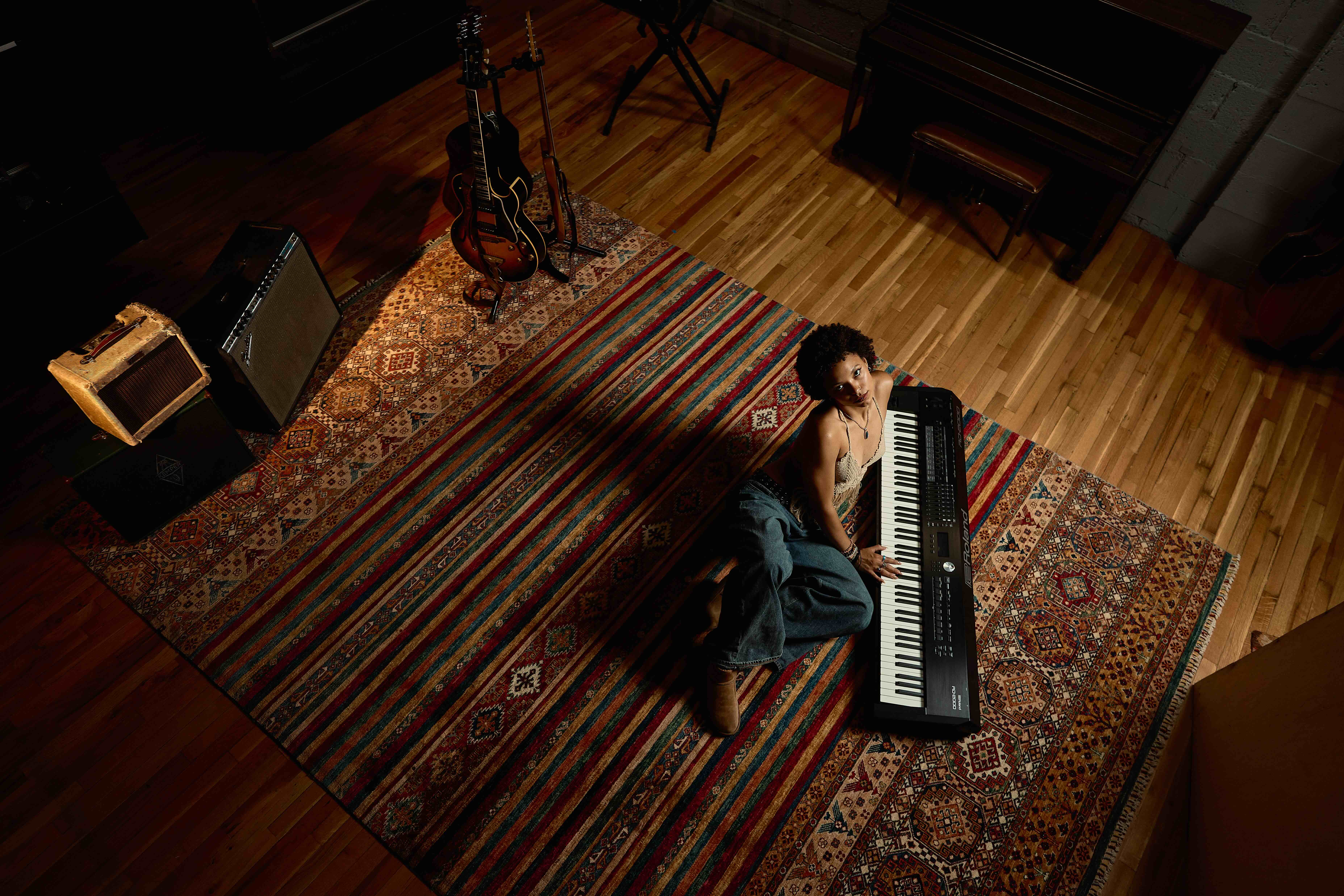 Picturd is Kai sitting on the floor next to a keyboard, surrounded by instruments. The Albuquerque native's new LP is the first released with her new label, BTTRSNC, providing her the freedom to solely focus on the creative aspect of music, she said. (Courtesy of Zach Hagy)