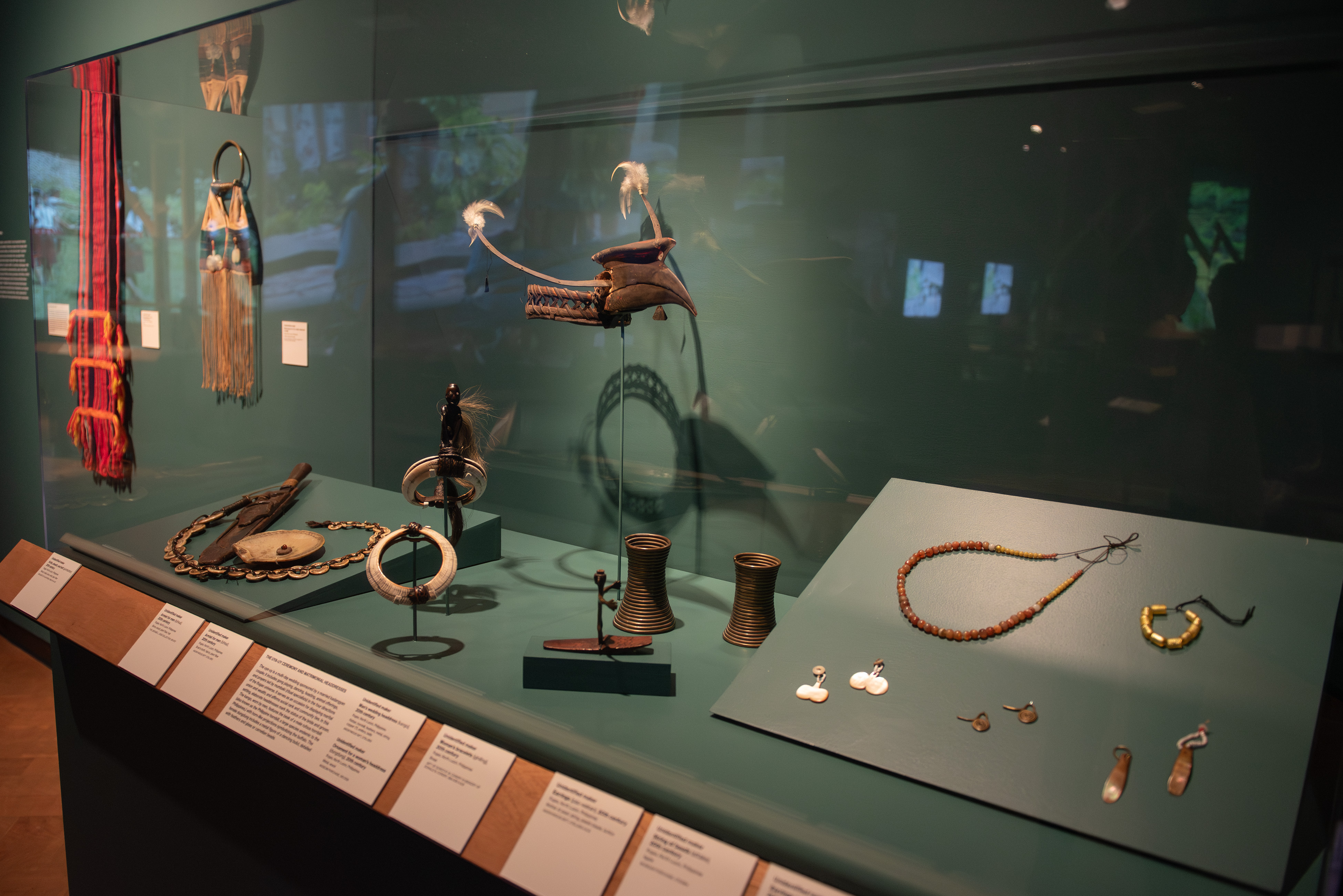 Shown are a few of the exhibition&squot;s elements in a display case. "Mountain Spirits" focuses on Ifugao culture, showcasing both spiritual and everyday life elements through a range of multimedia pieces. (Karla Cardenas-Felipe/Daily Bruin staff)