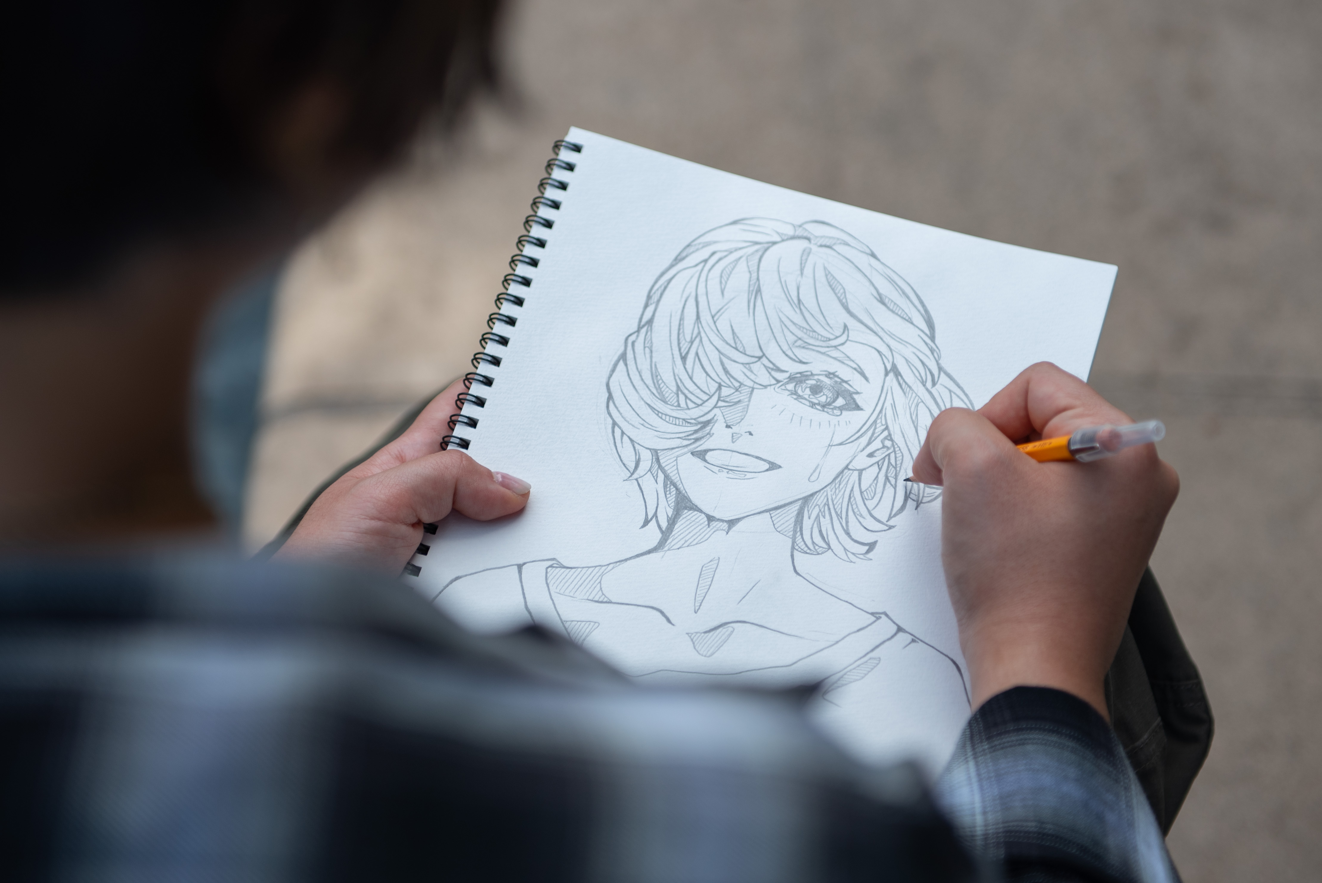 Pictured is one of Uchiumi's pencil-and-paper sketches. The process for her pieces starts in a notebook and continues in a digital art app, a process that can take up to five to nine hours.  (Selin Filiz/Assistant Photo editor)
