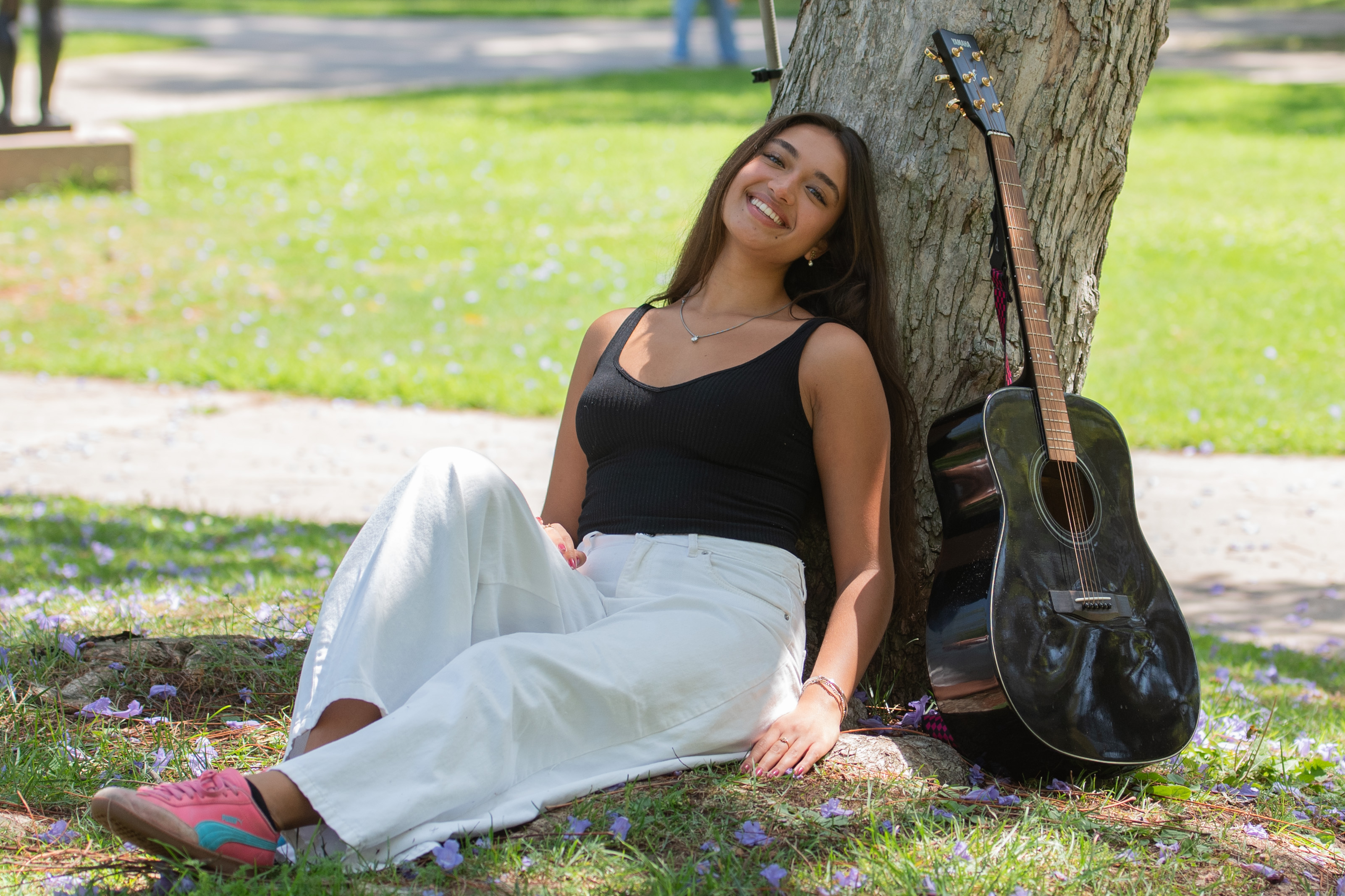 Wimmer smiles as she poses for a picture, wearing a black and white outfit with pink and blue shoes. As a model, photographer, actress and musician, the student said she is particularly drawn to the latter two due to the activities' storytelling nature. (Purvi Singhania/Daily Bruin)