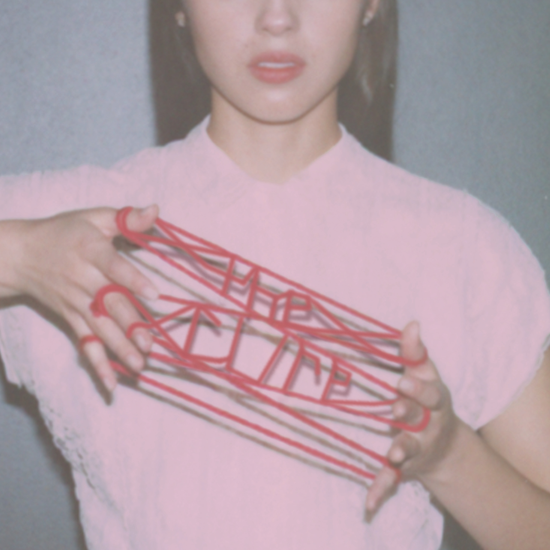 A shot of Olivia Rodrigo&squot;s torso and half of her face shows the singer&squot;s hand wrapped in red yarn, forming the words "the cure." Rodrigo&squot;s second single debuted on May 21 along with a stop-motion music video. (Courtesy of Olivia Rodrigo, under exclusive license to Geffen Records)
