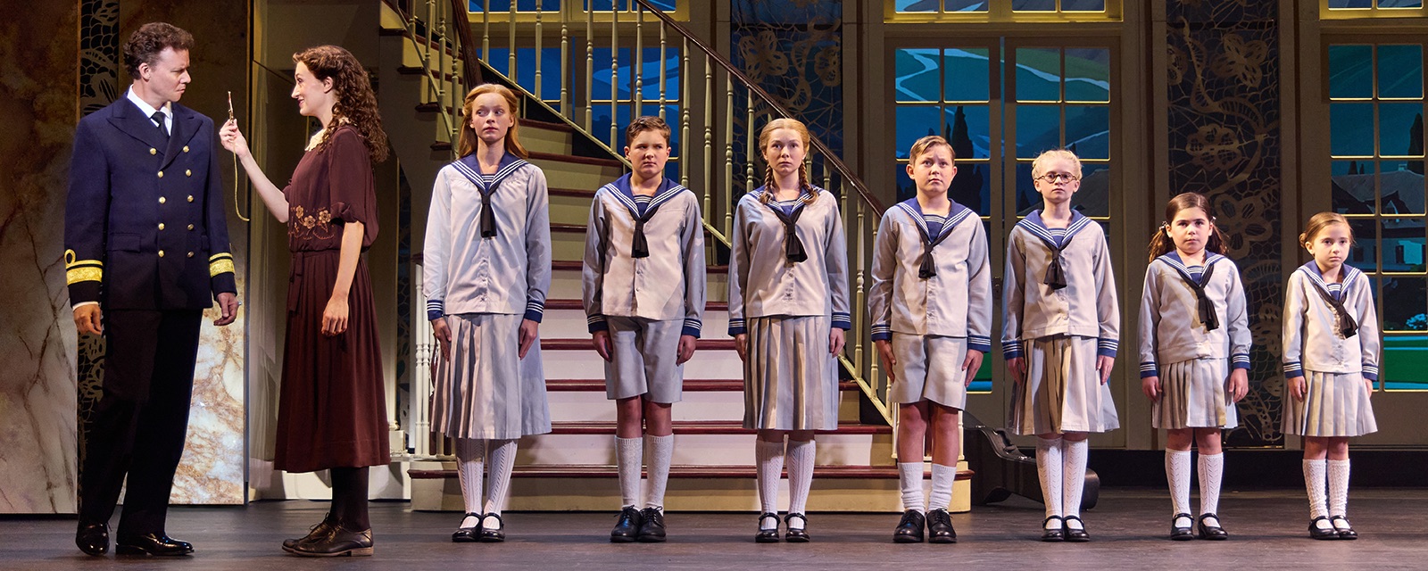 Cayleigh Capaldi and Kevin Earley converse alongside Earley's seven children. Unlike other adaptations, Pantages's show remains faithful to the original production. (Courtesy of Jeremy Daniel)