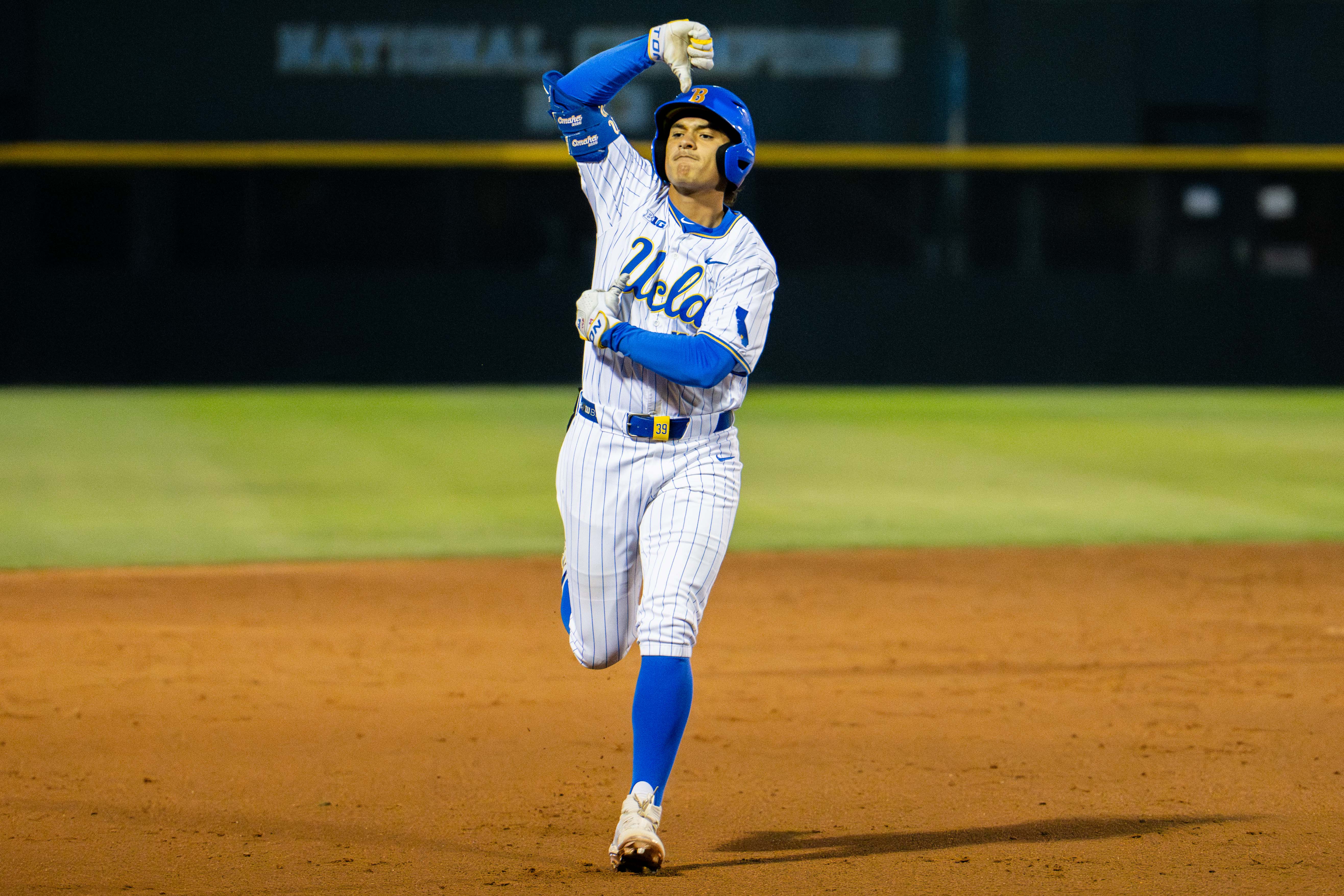 Junior first baseman Mulivai Levu celebrates while rounding the bases. (Kai Dizon/Daily Bruin senior staff)