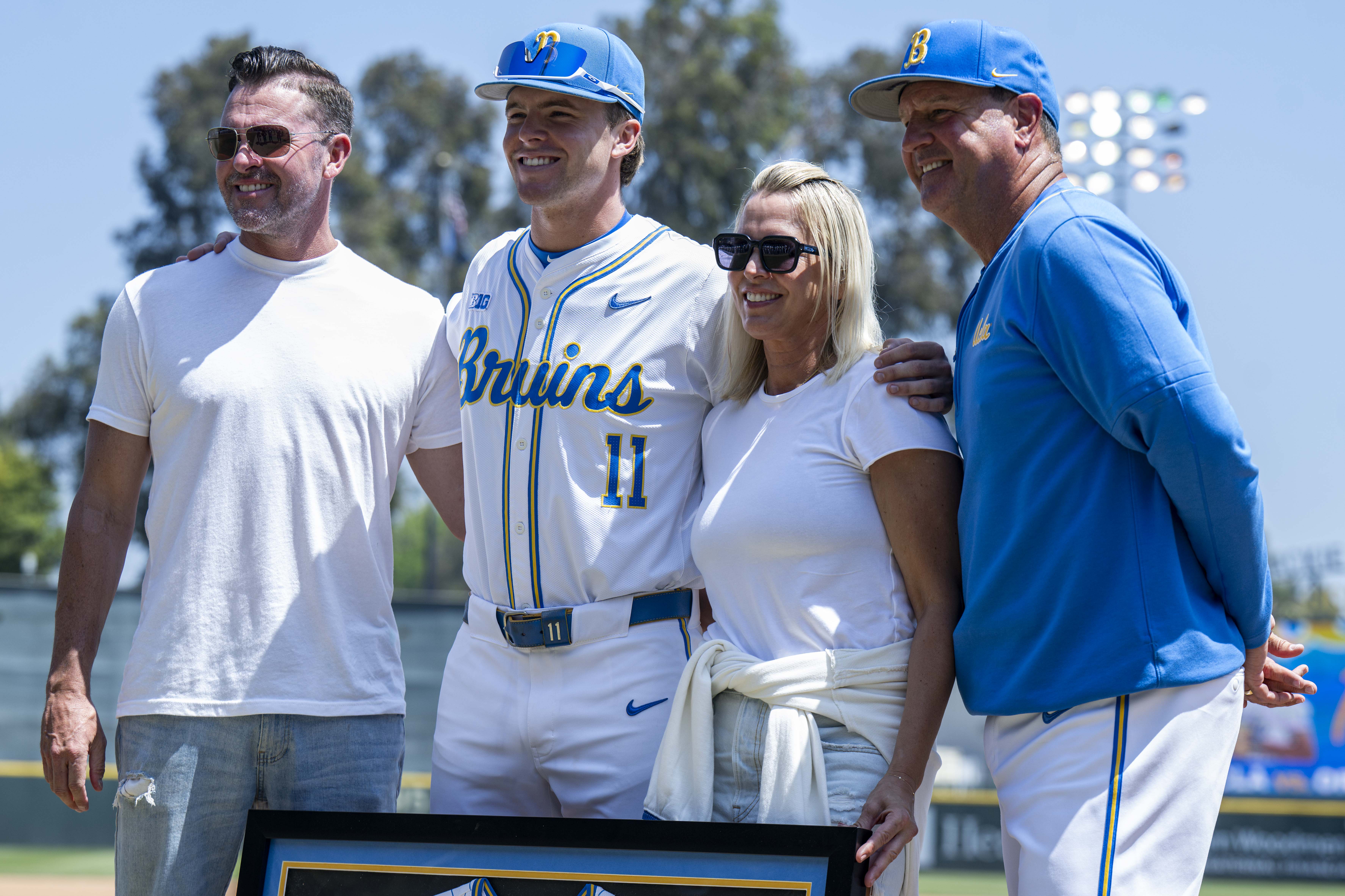 Payton Brennan (second from left) poses for a senior day photo. The redshirt junior right fielder went 3-for-4 Sunday. (Kai Dizon/Daily Bruin senior staff)