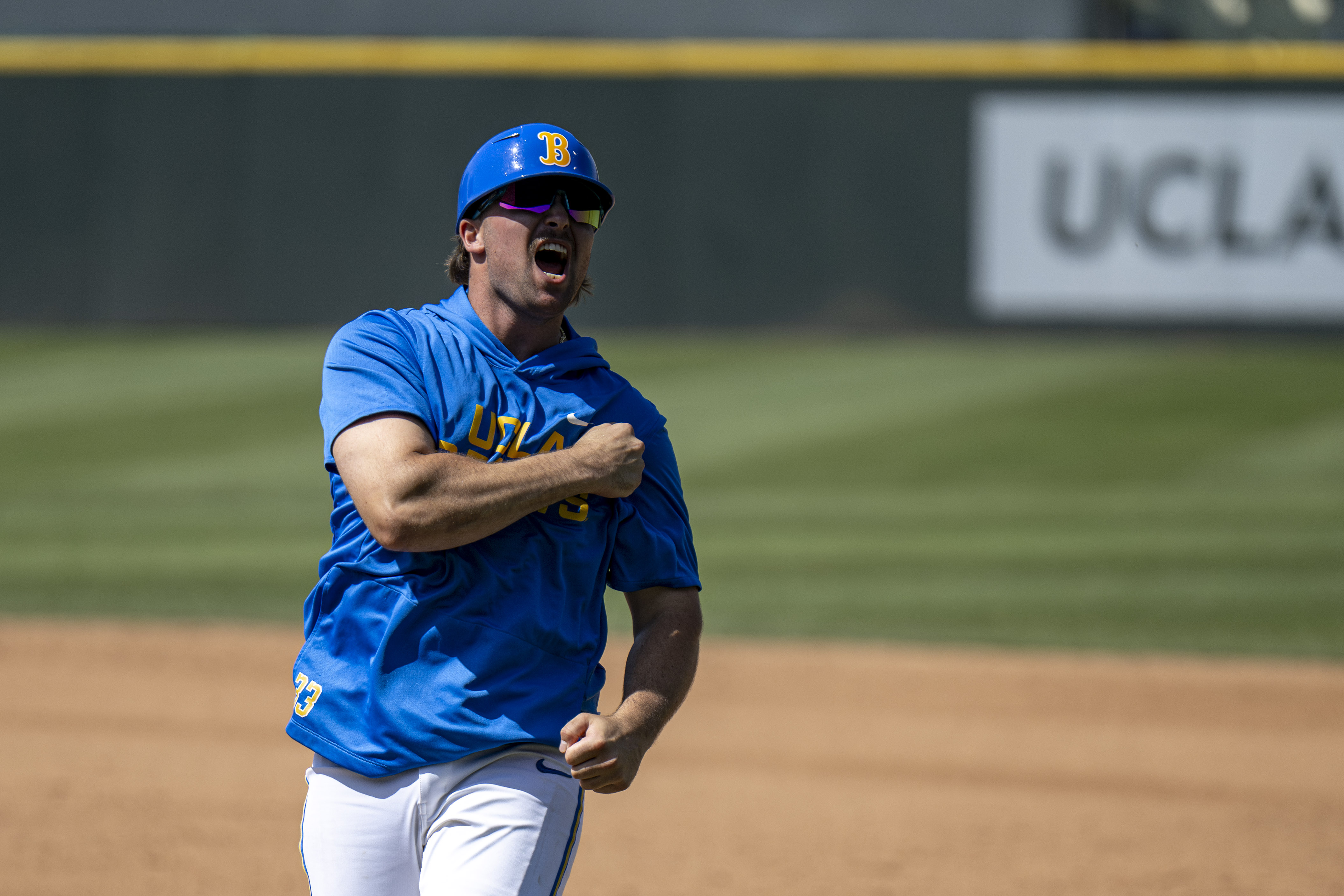 Junior catcher Blake Balsz celebrates after West's go-ahead grand slam in the eighth. Balsz, who's out for the season due to injury, was the Bruins' first base coach Sunday. (Kai Dizon/Daily Bruin senior staff)
