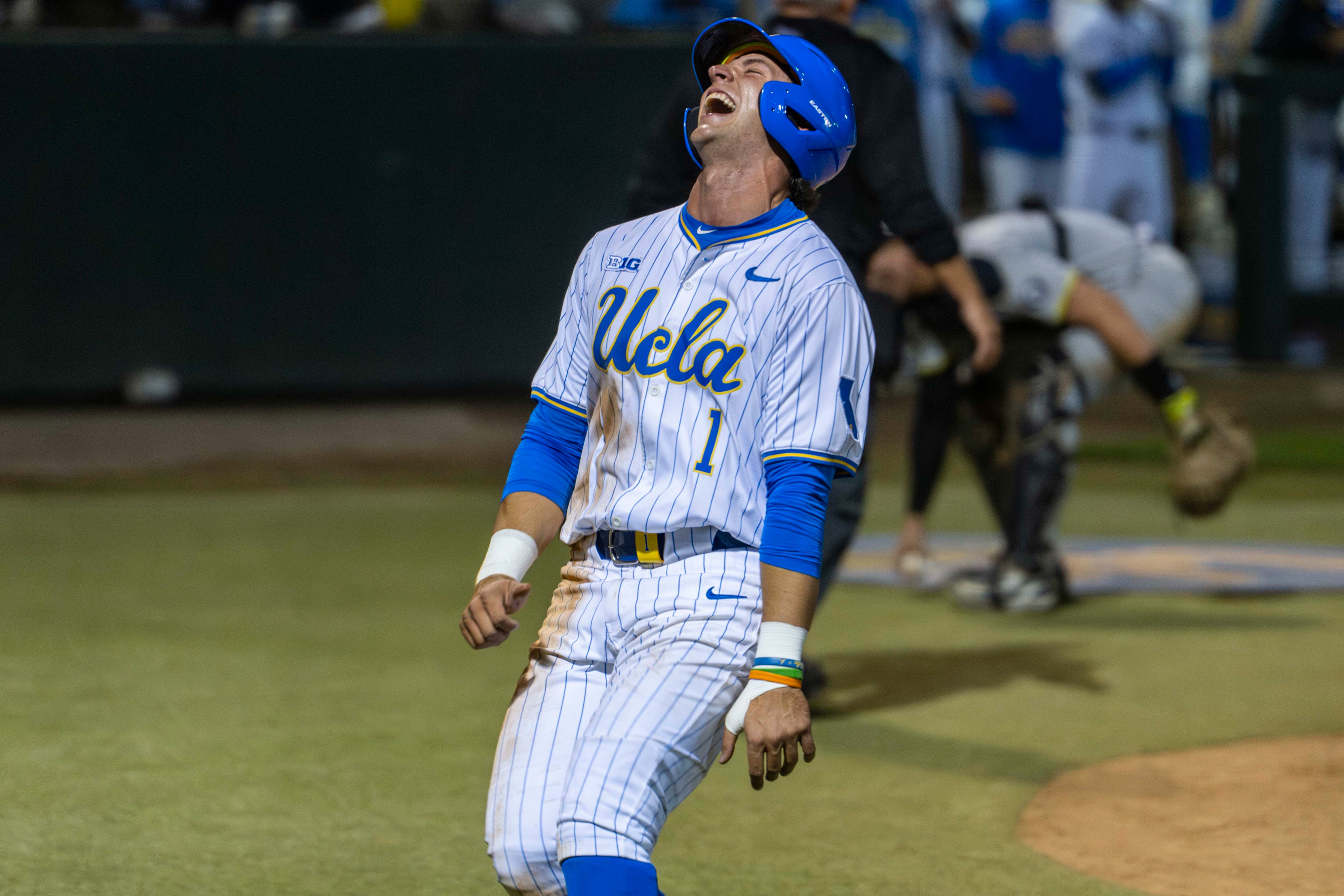 Roch Cholowsky smiles after scampering home on a wild pitch in the bottom of the fourth. The junior shortstop scored just minutes after a Duck cleated his right hand, causing it to bleed. (Kai Dizon/Daily Bruin senior staff)