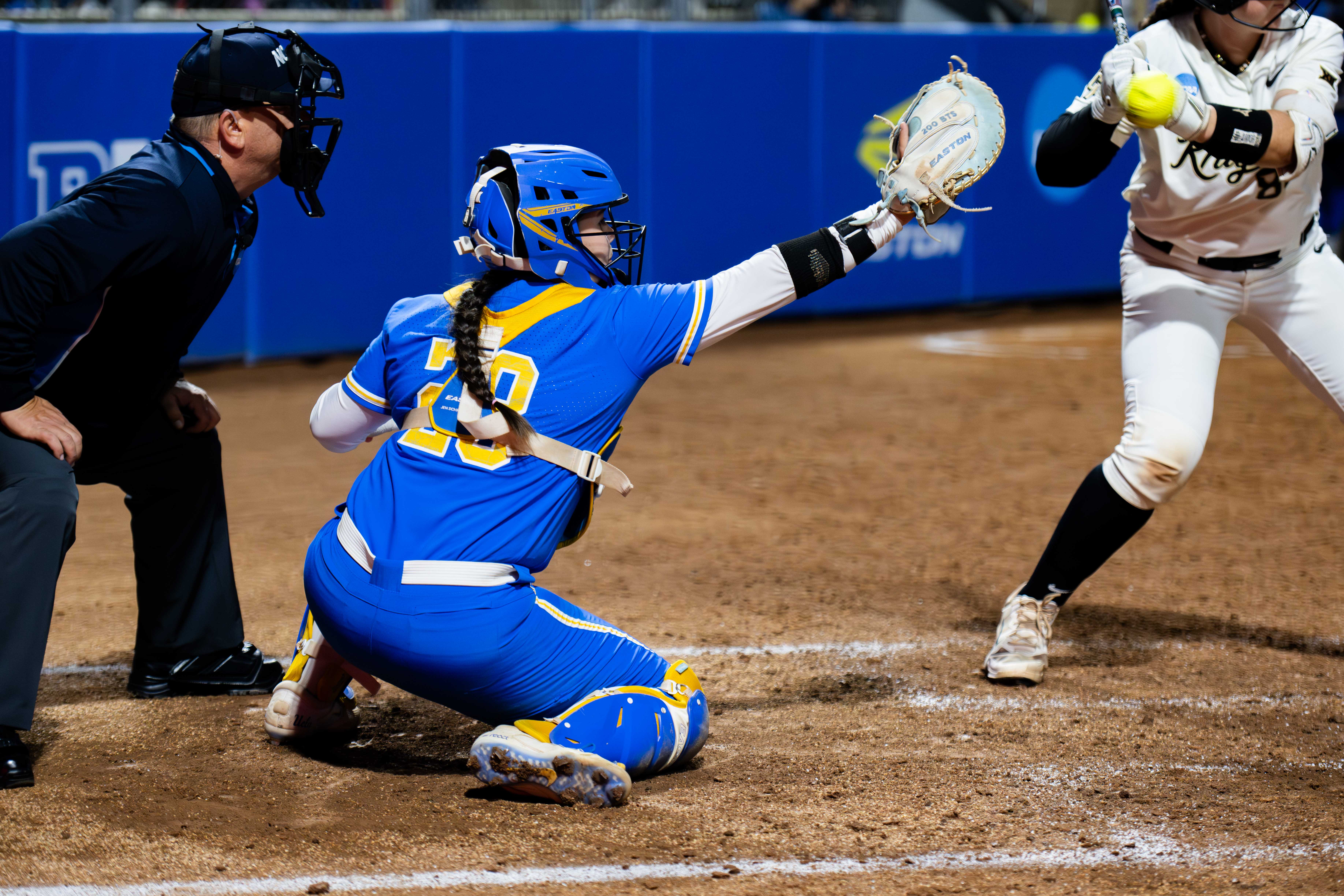 Redshirt junior catcher Alexis Ramirez prepares to catch a pitch while crouching behind the plate. Ramirez earned her first Big Ten All-Defensive Team and NFC All-West Region Second Team selections this year. (Presley Liu/Daily Bruin staff)