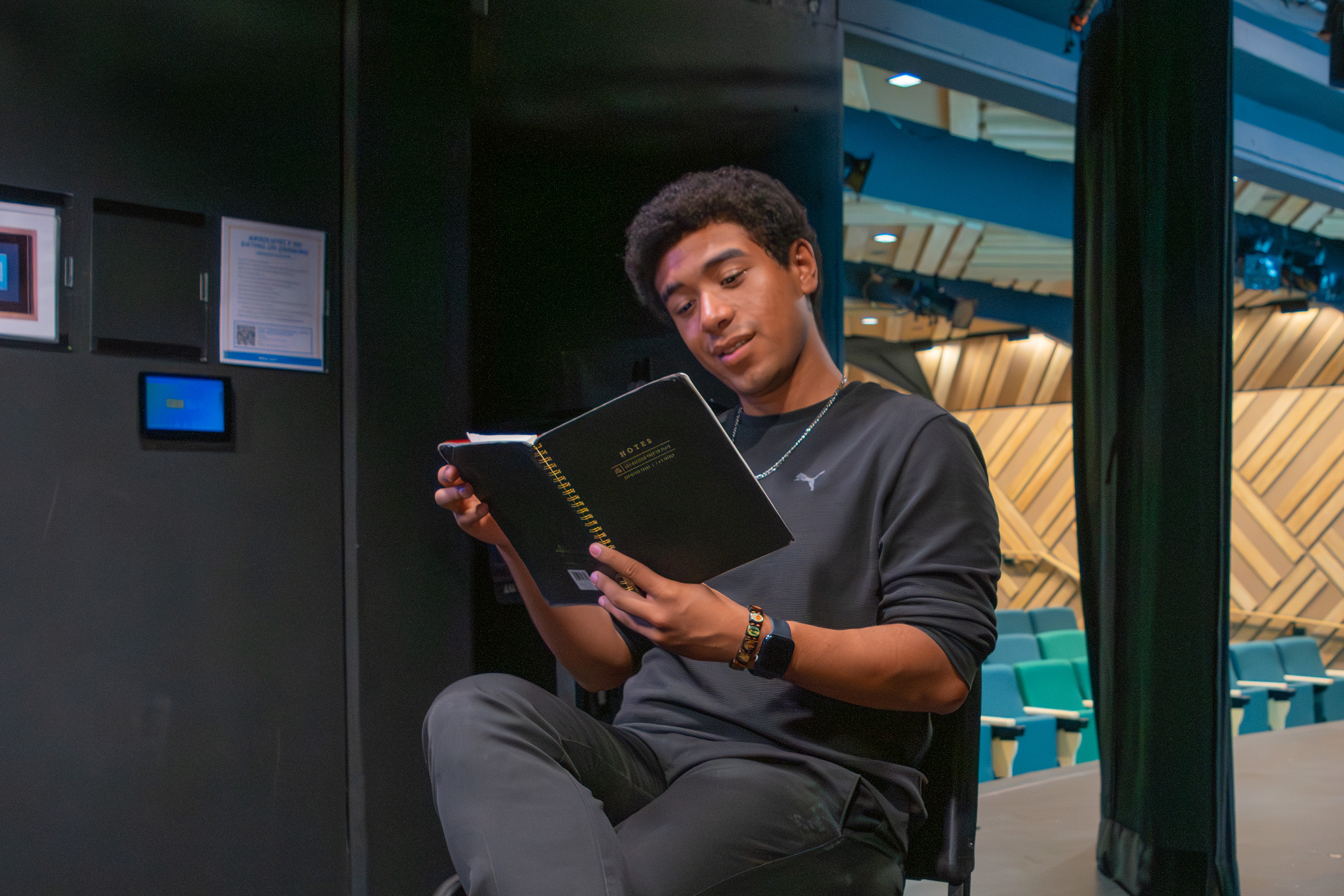 Smith studies a notebook. He said he discovered his passion for theater while playing Benny in