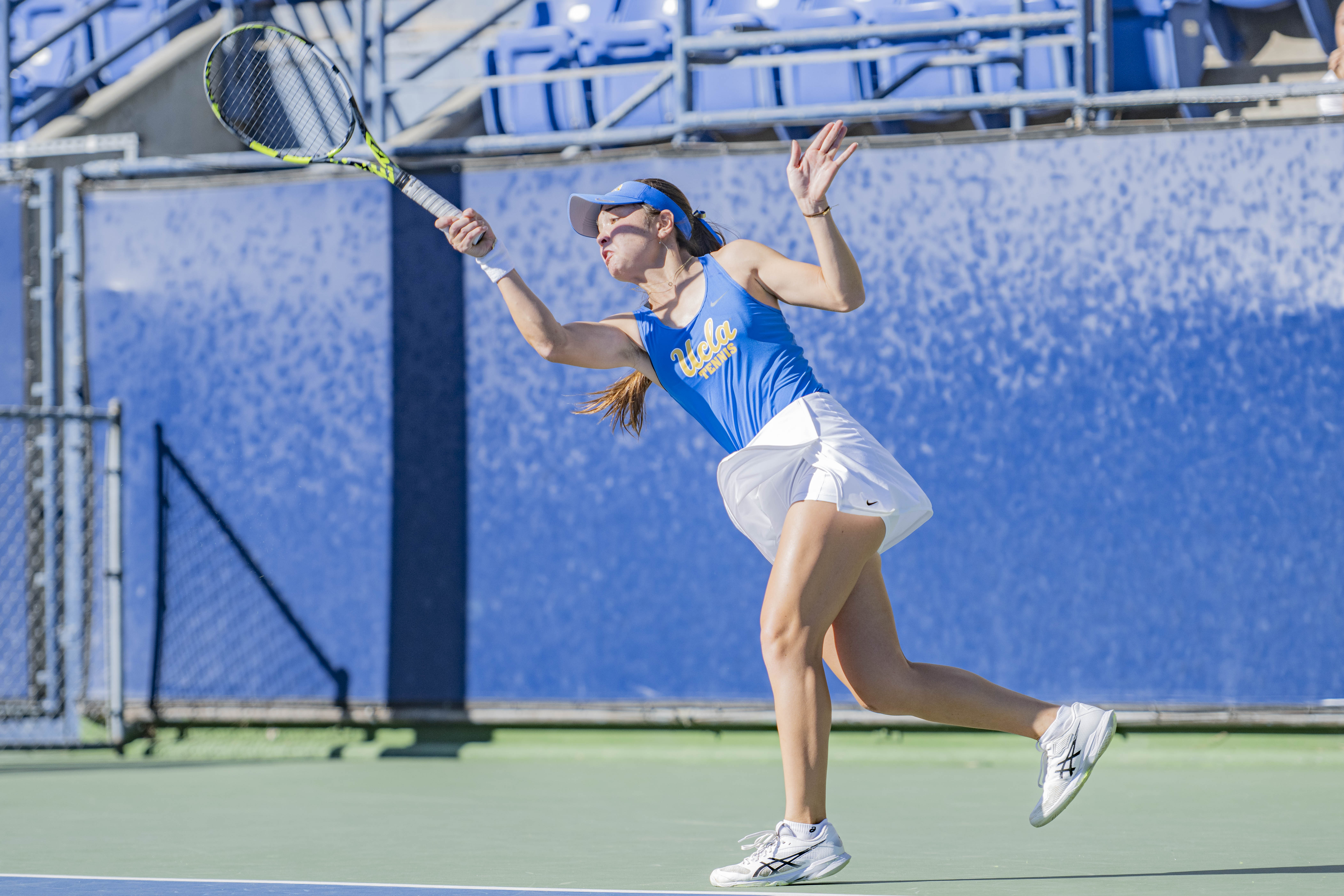 Freshman Mayu Crossley swings her racket. Crossley led UCLA women's tennis in dual-match record, helping her win the Big Ten Freshman of the Year award. (Brianna Carlson/Daily Bruin staff)