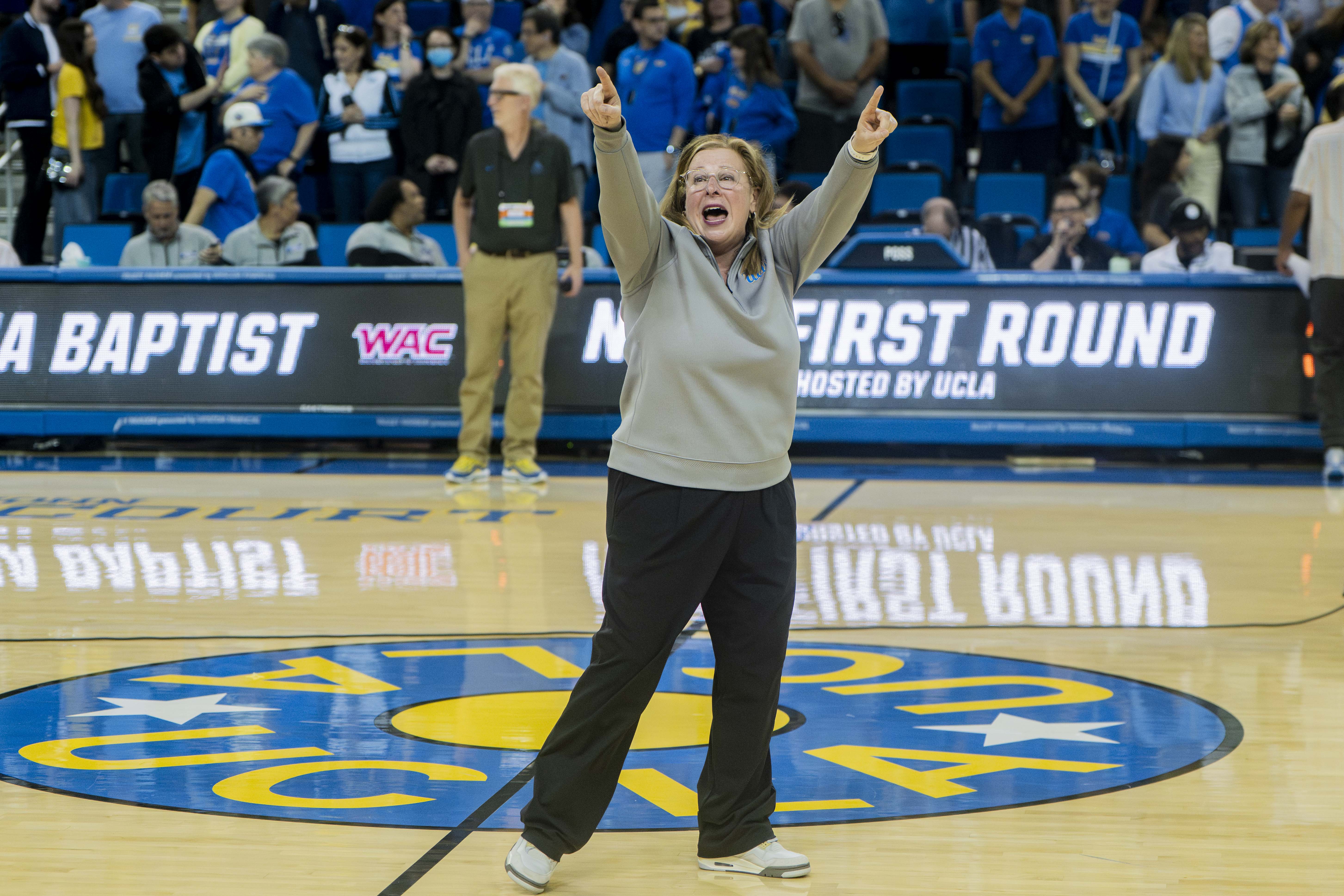 Coach Cori Close celebrates and points to the stands in Pauley Pavilion. Close led UCLA women's basketball to its second Big Ten championship in as many years. (Leydi Cris Cobo Cordon/Daily Bruin senior staff)