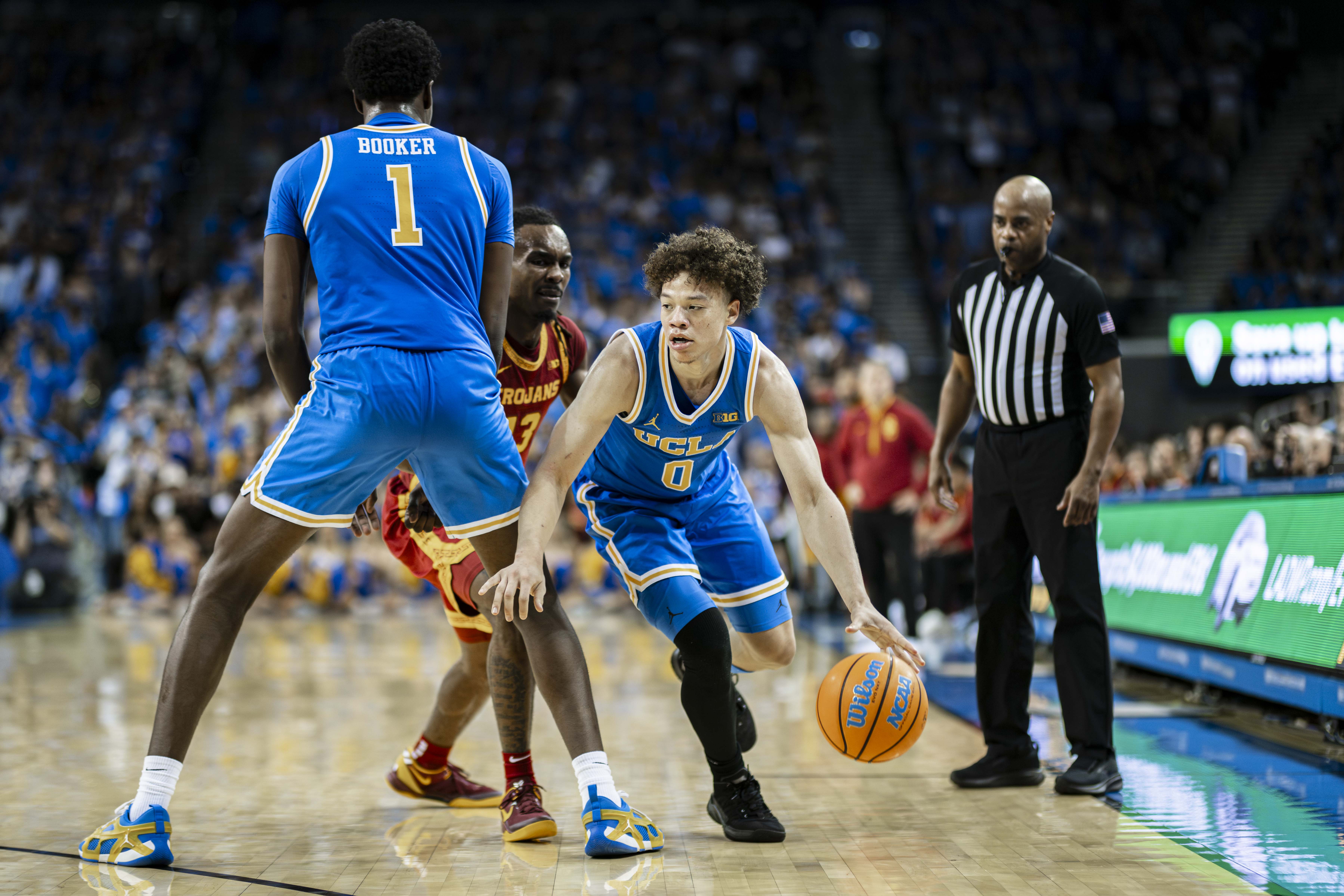 Sophomore guard Trent Perry dribbles past a screen. Perry nearly quadrupled his points per game average from his first to second season at UCLA. (Aidan Sun/Daily Bruin senior staff)