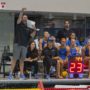 Former UCLA women’s water polo coach Adam Wright stands by the pool deck and points while holding a sheet to his mouth. Wright led the program to its first national championship since 2009 in 2024. (Daily Bruin file photo)