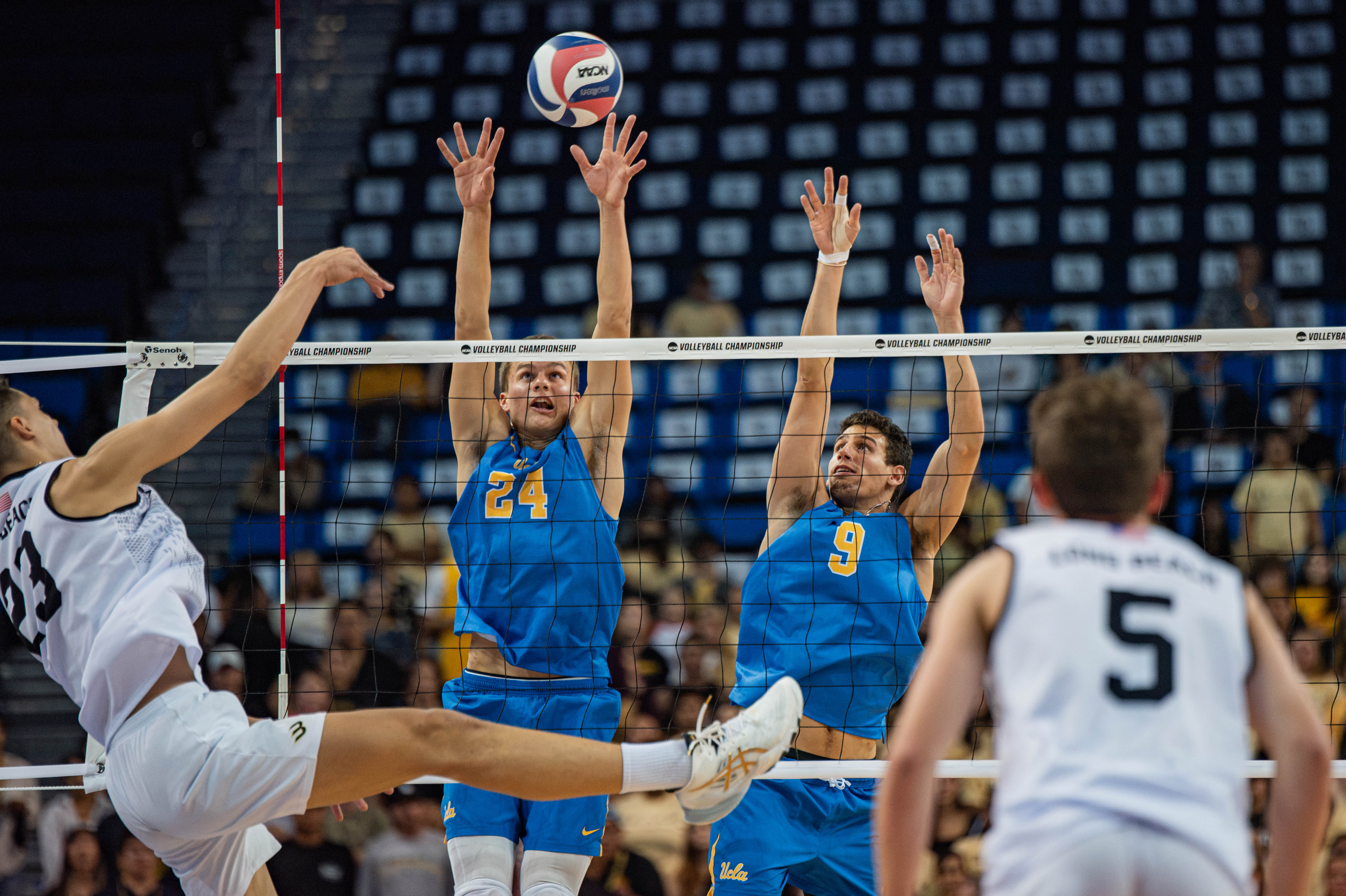 Miles Partain (left) rises to block an attack alongside a teammate. He was one of three finalists for the 2022 Lloy Ball Award, given to the nation's top setter. (Daily Bruin file photo)
