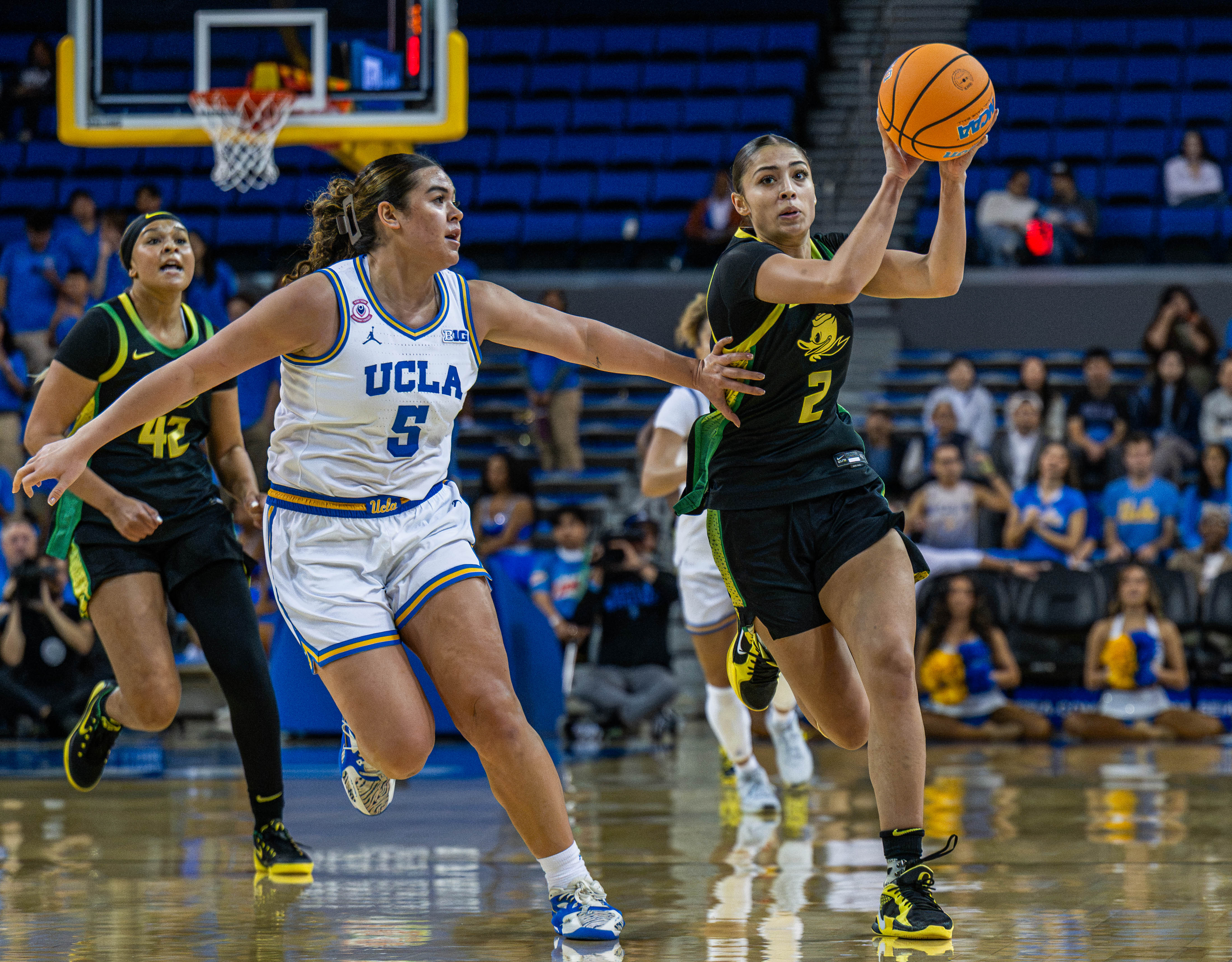 Duck guard Katie Fiso attempts to evade former Bruin guard Charlisse Leger-Walker in a game Dec. 7 at Pauley Pavilion. Fiso was an All-Big Ten second team selection last year. (Brianna Carlson/Daily Bruin staff)
