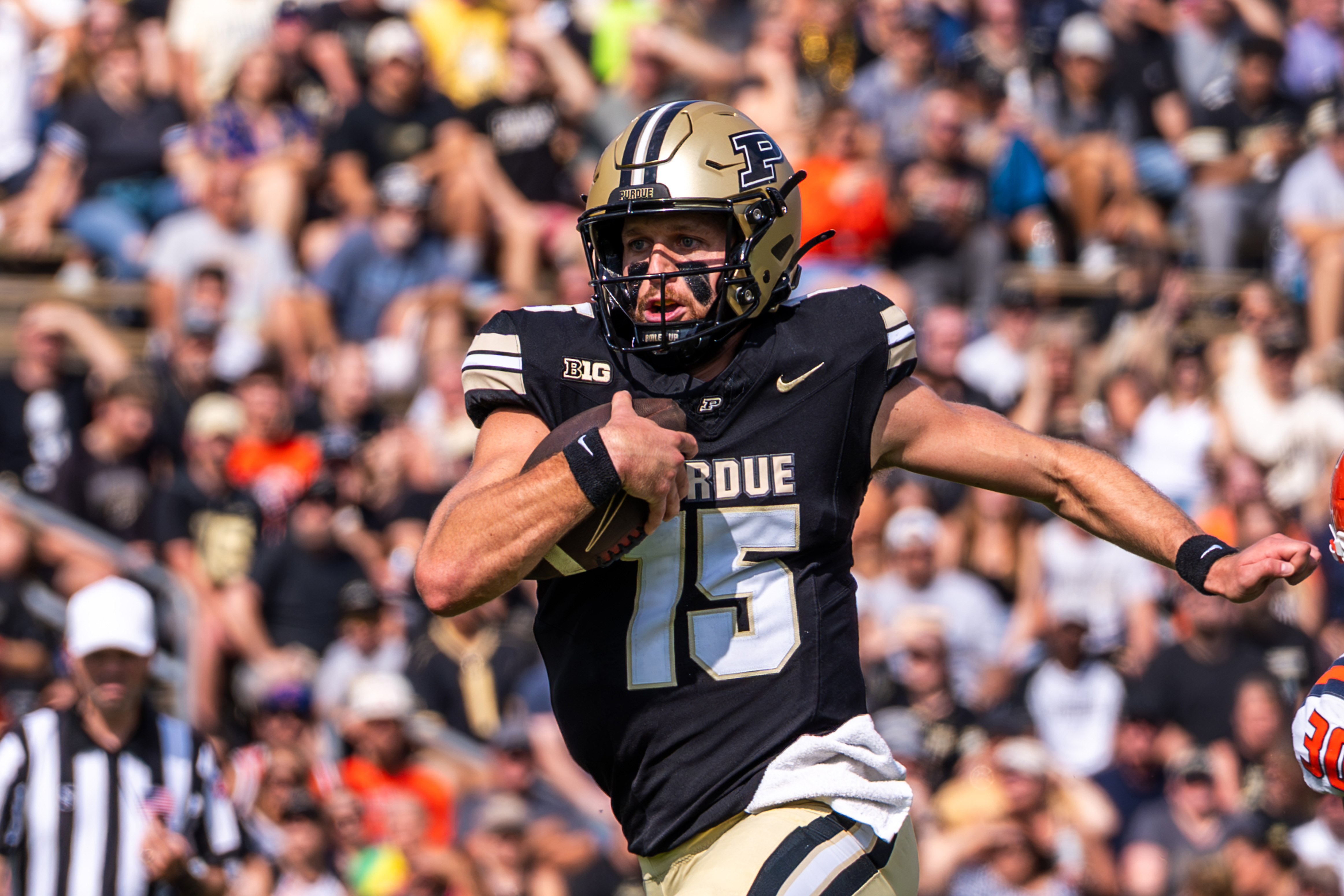 Purdue quarterback Ryan Browne runs with the football. Browne logged 2,153 passing yards and threw for nine touchdowns last season with the Boilermakers. (Courtesy of Purdue Athletics)