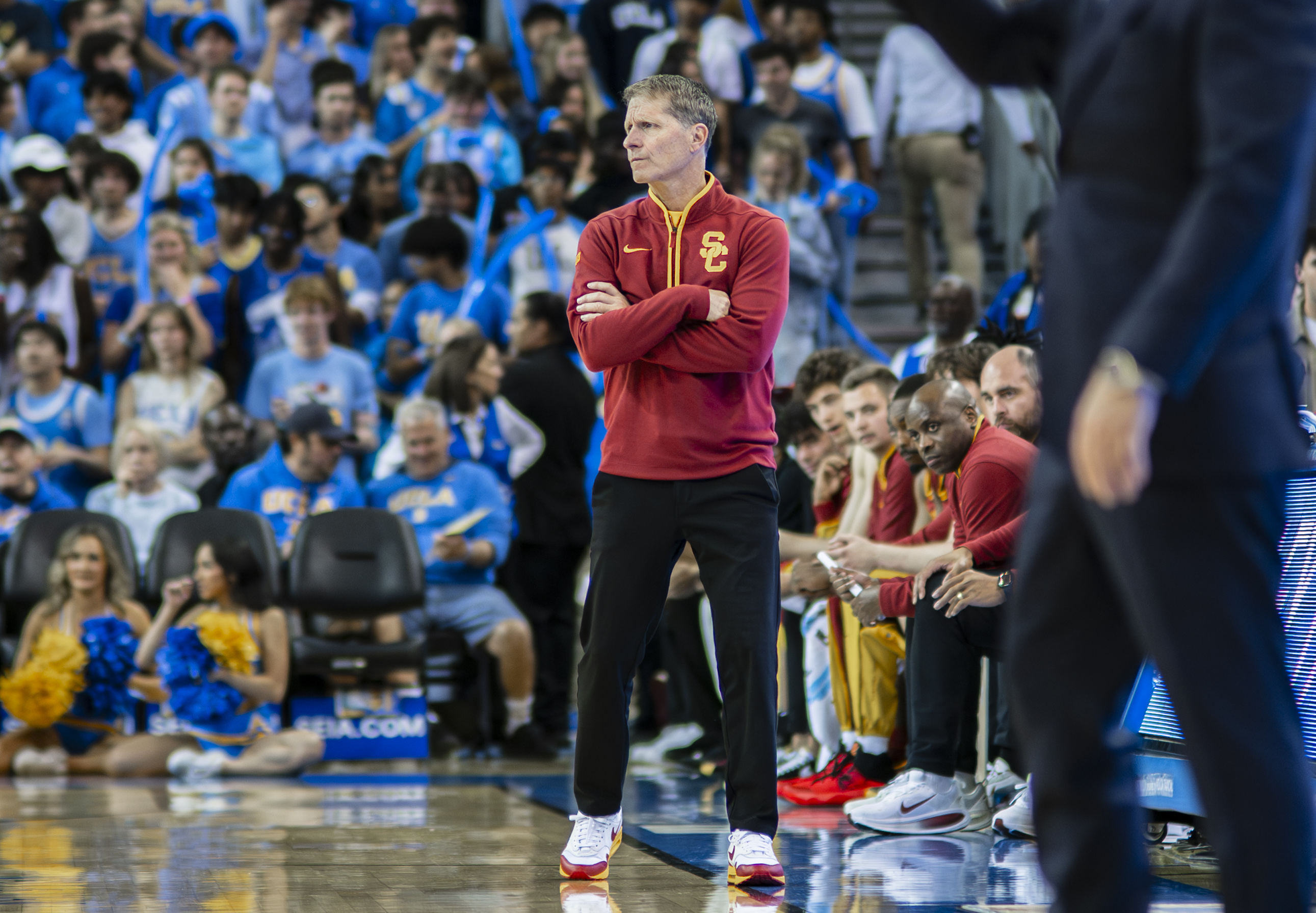 USC men's basketball coach Eric Musselman stands on the sideline with his arms crossed. Musselman enters his third year helming the Trojans. (Daily Bruin file photo)