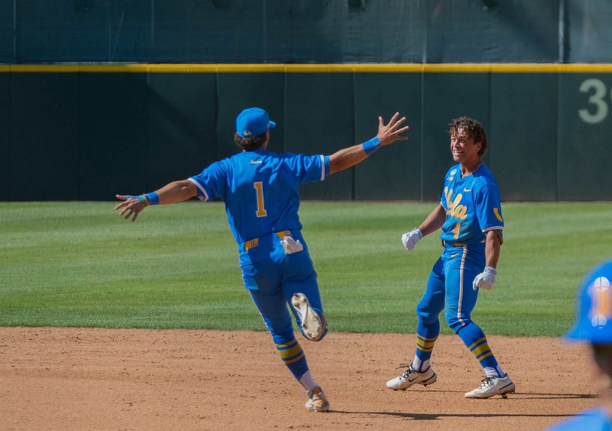 Shortstop Roch Cholowsky raises his arms as he celebrates with infielder Phoenix Call. Cholowsky was selected with the No. 1 overall pick in the MLB Draft in July. (Kai Dizon/Assistant Photo editor)