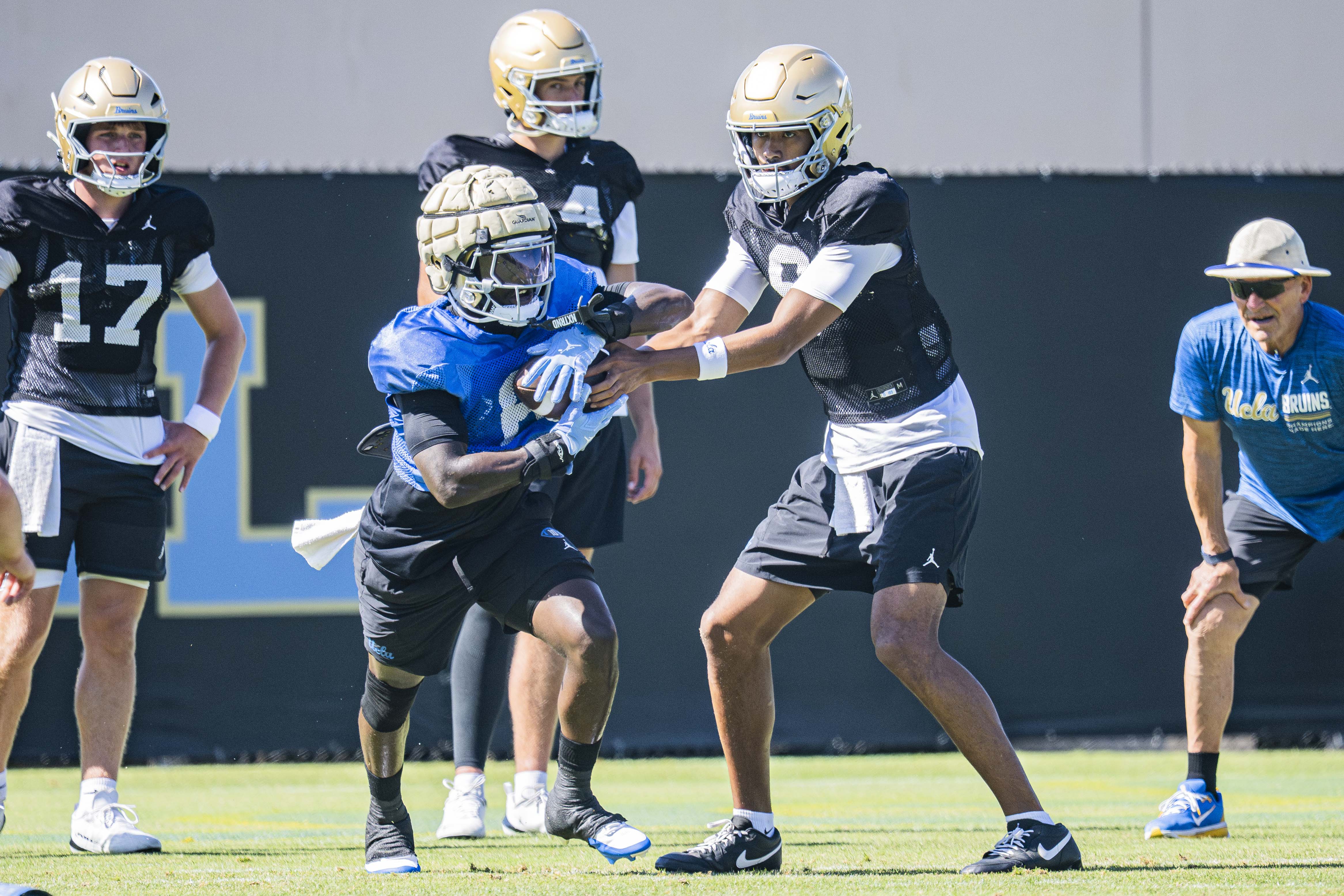 Fifth-year running back Anthony Woods takes a handoff from redshirt junior quarterback Nico Iamaleava during the team’s practice on Monday, Aug. 17, 2026, at Spaulding Field. (Kai Dizon/Assistant Photo editor)