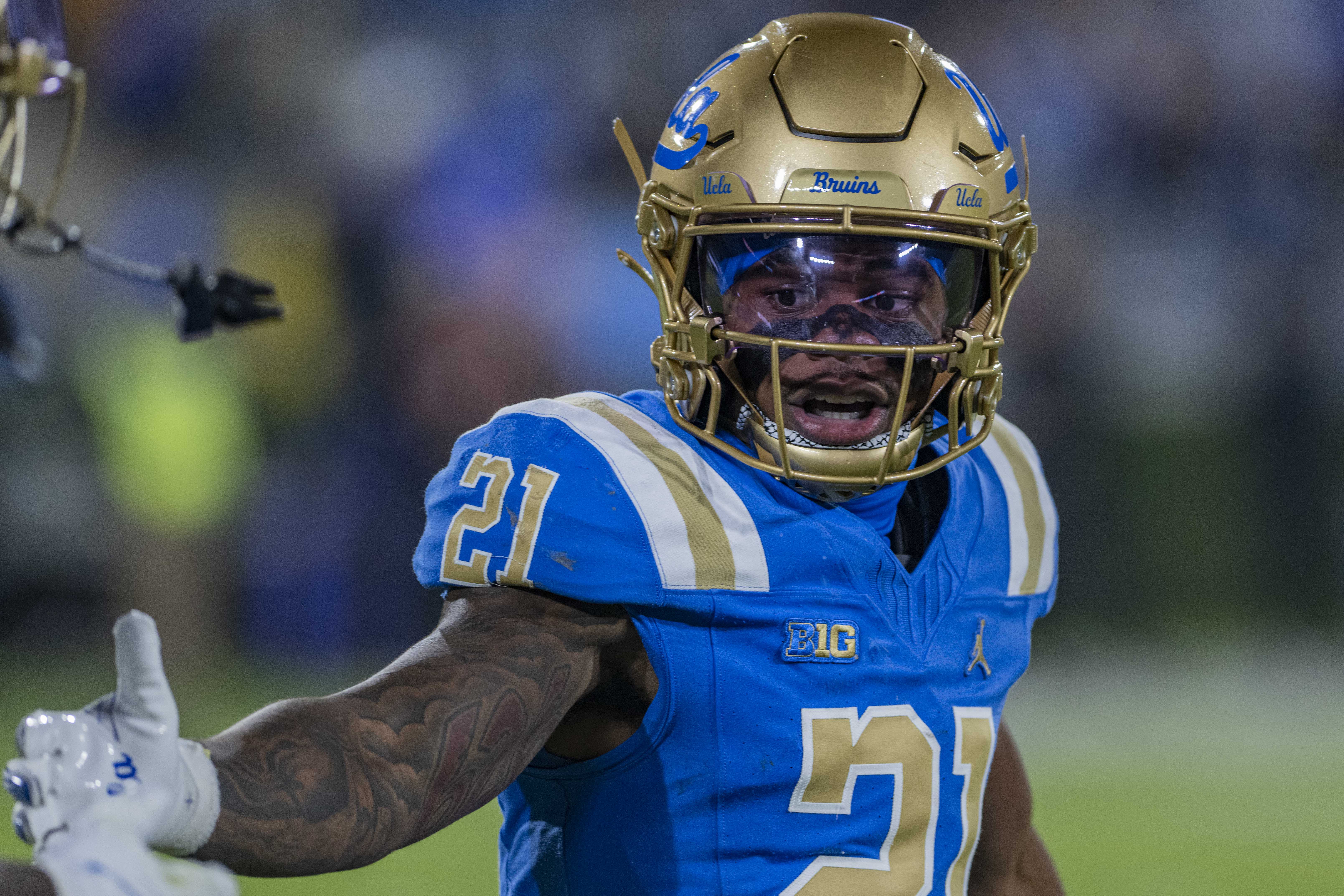 Senior running back Jaivian Thomas greets a teammate as they run off the field against Washington on Nov. 22, 2025, at the Rose Bowl. (Michael Gallaghar/Daily Bruin senior staff)