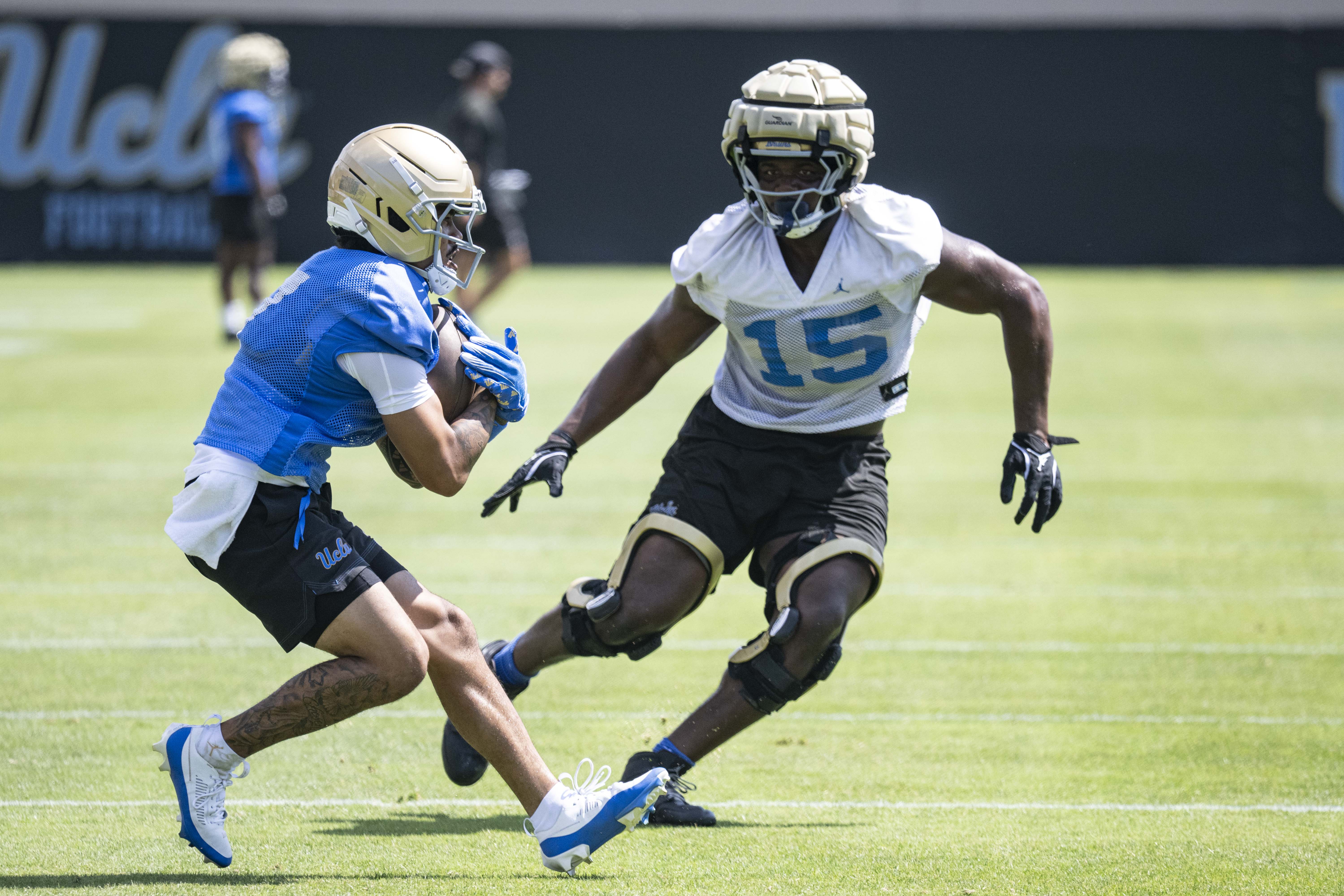 Junior defensive lineman Sahir West tracks down senior wide receiver Mikey Matthews during a punt return drill on Aug. 6 Spaulding Field. West won the Sun Belt Freshman of the Year award last year with James Madison. (Kai Dizon/Assistant Photo editor)
