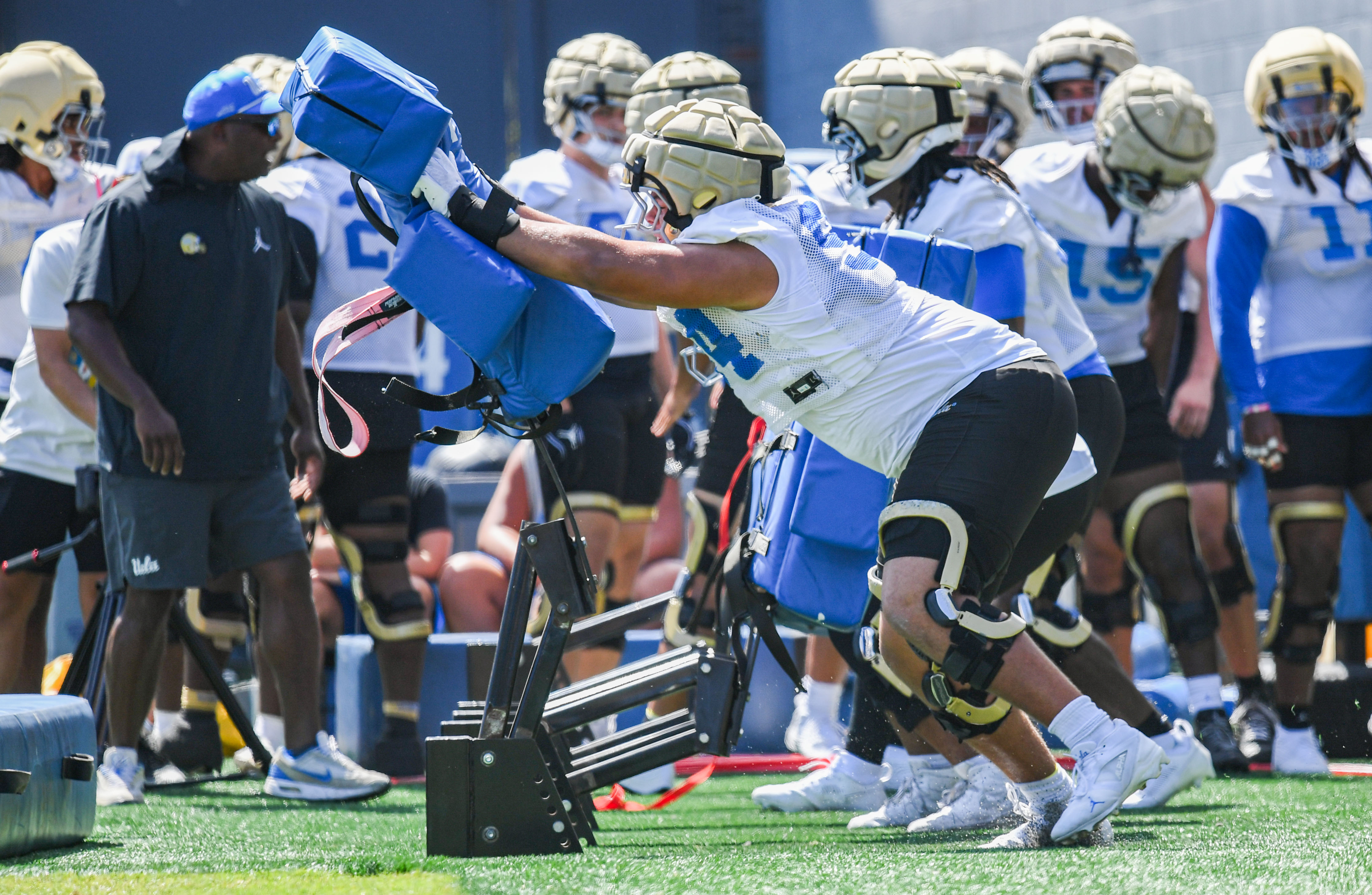 Freshman defensive lineman Marcus Almada thrusts his arms into a training sled during practice. (Kai Dizon/Assistant Photo editor)