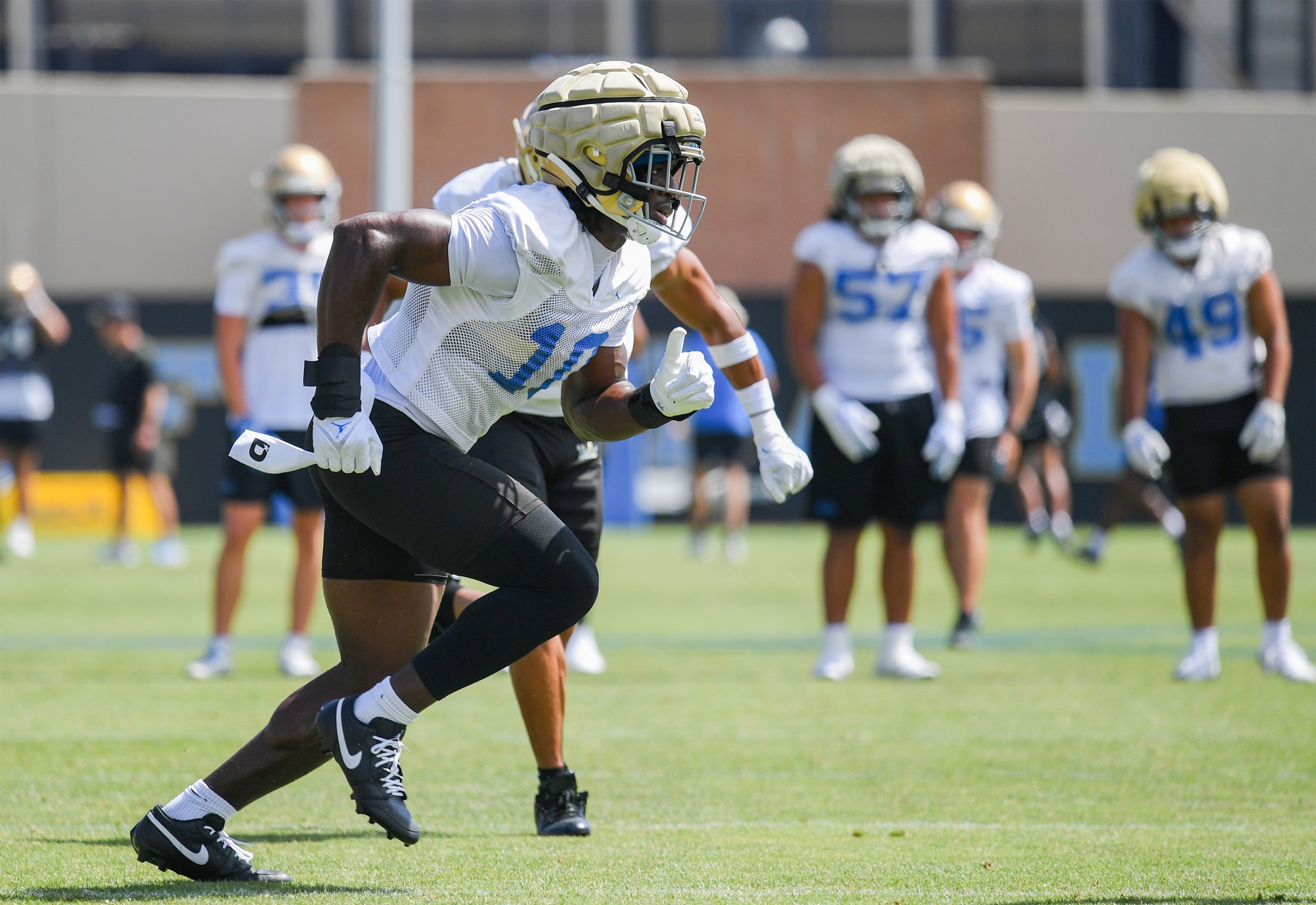 Senior linebacker Sammy Omosigho runs during an Aug. 7 practice at Spaulding Field. (Kai Dizon/Assistant Photo editor)