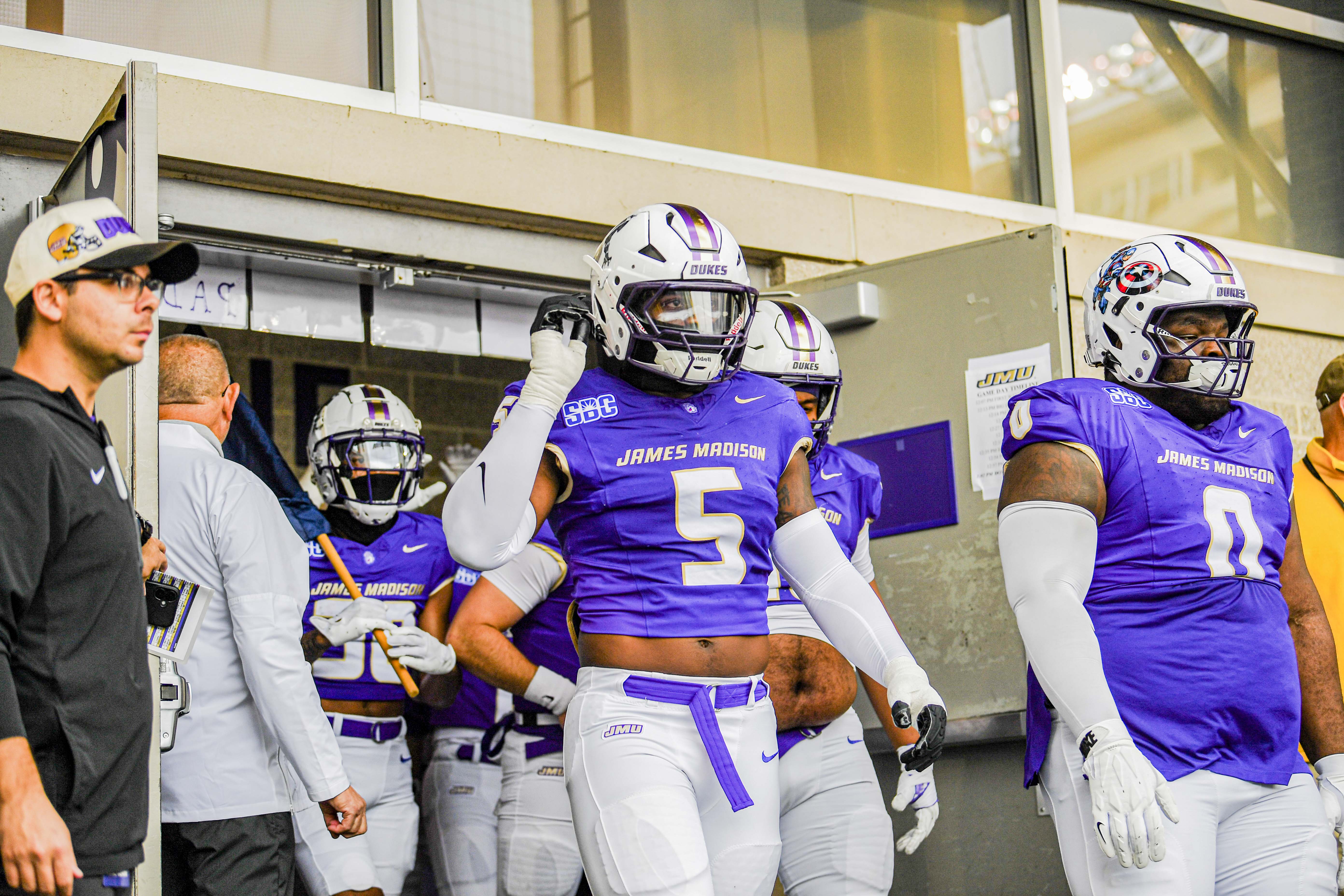 Former James Madison linebacker Trent Hendrick walks out of the tunnel alongside his teammates. (Courtesy of JMU Athletics Photography)