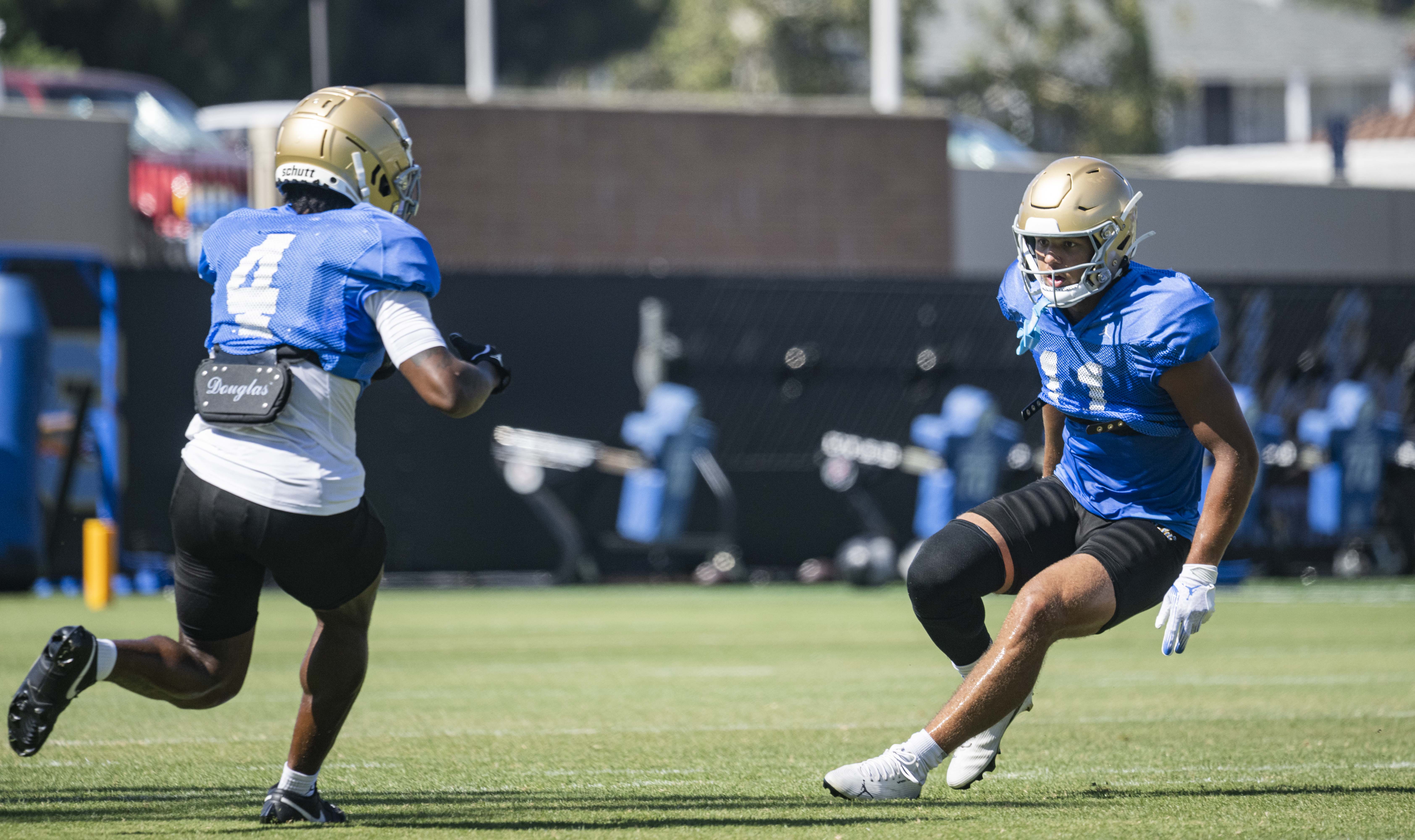 Senior wide receiver Landon Ellis tracks down senior wide receiver Semaj Morgan during a punt return drill. (Kai Dizon/Assistant Photo editor)