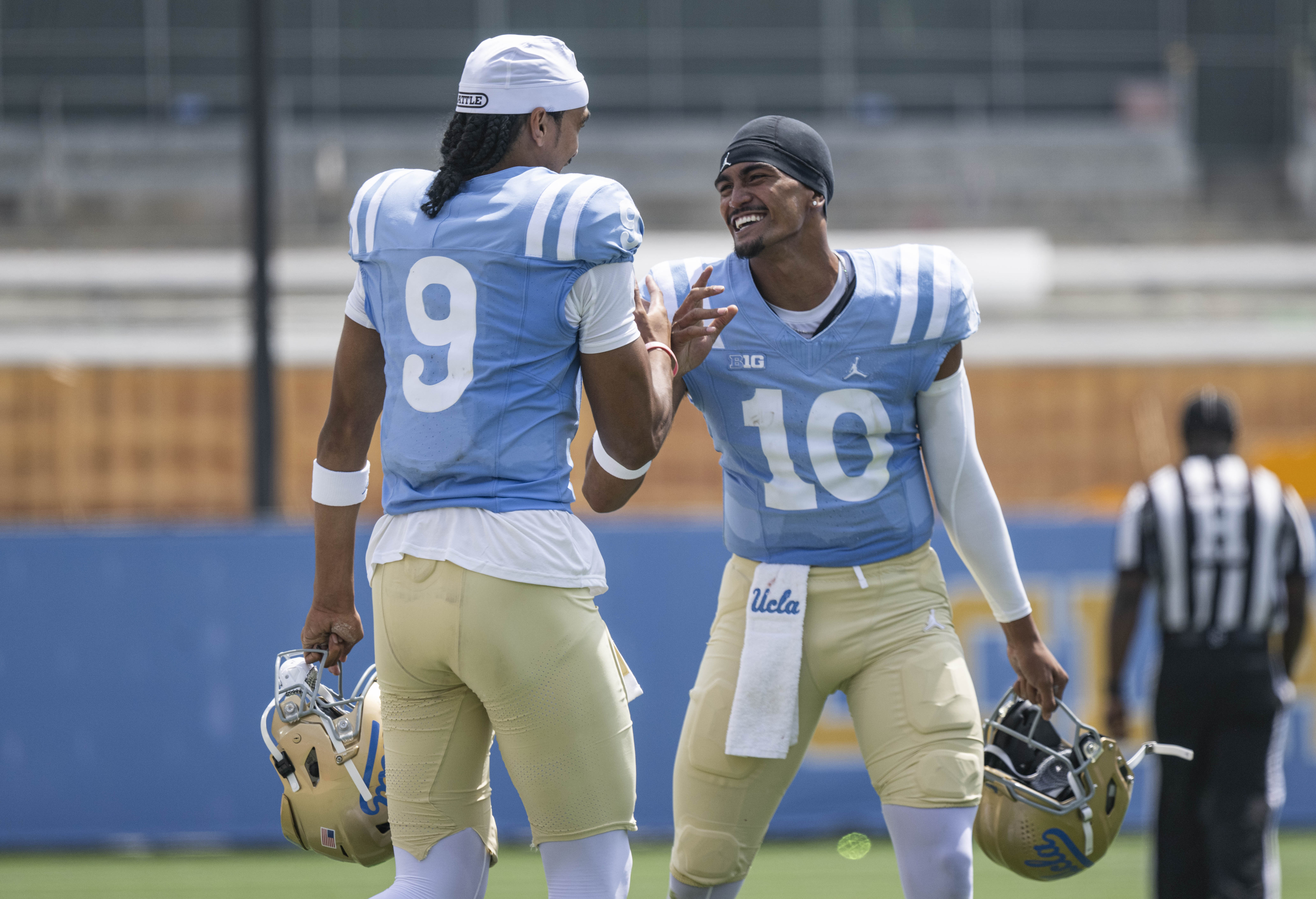 Brothers Nico Iamaleava (left) and sophomore quarterback Madden Iamaleava (right) greet each other after competing for opposite teams in the Bruins’ Spring Game. Madden beat his older brother in the scrimmage. (Kai Dizon/Assistant Photo editor)