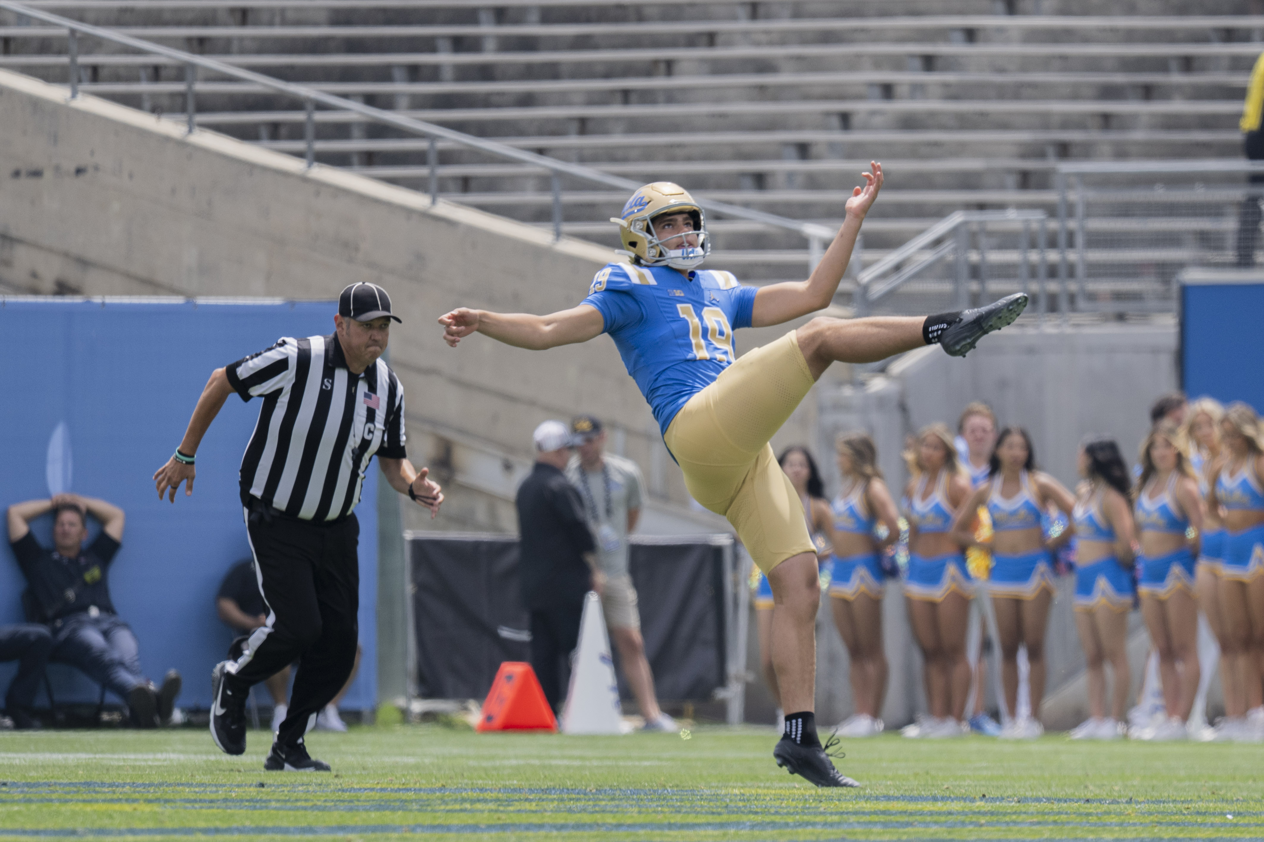 Sophomore punter Lennox Miller watches the ball sail off his right leg during the Bruins’ spring game May 2 at the Rose Bowl. (Kai Dizon/Assistant Photo editor)