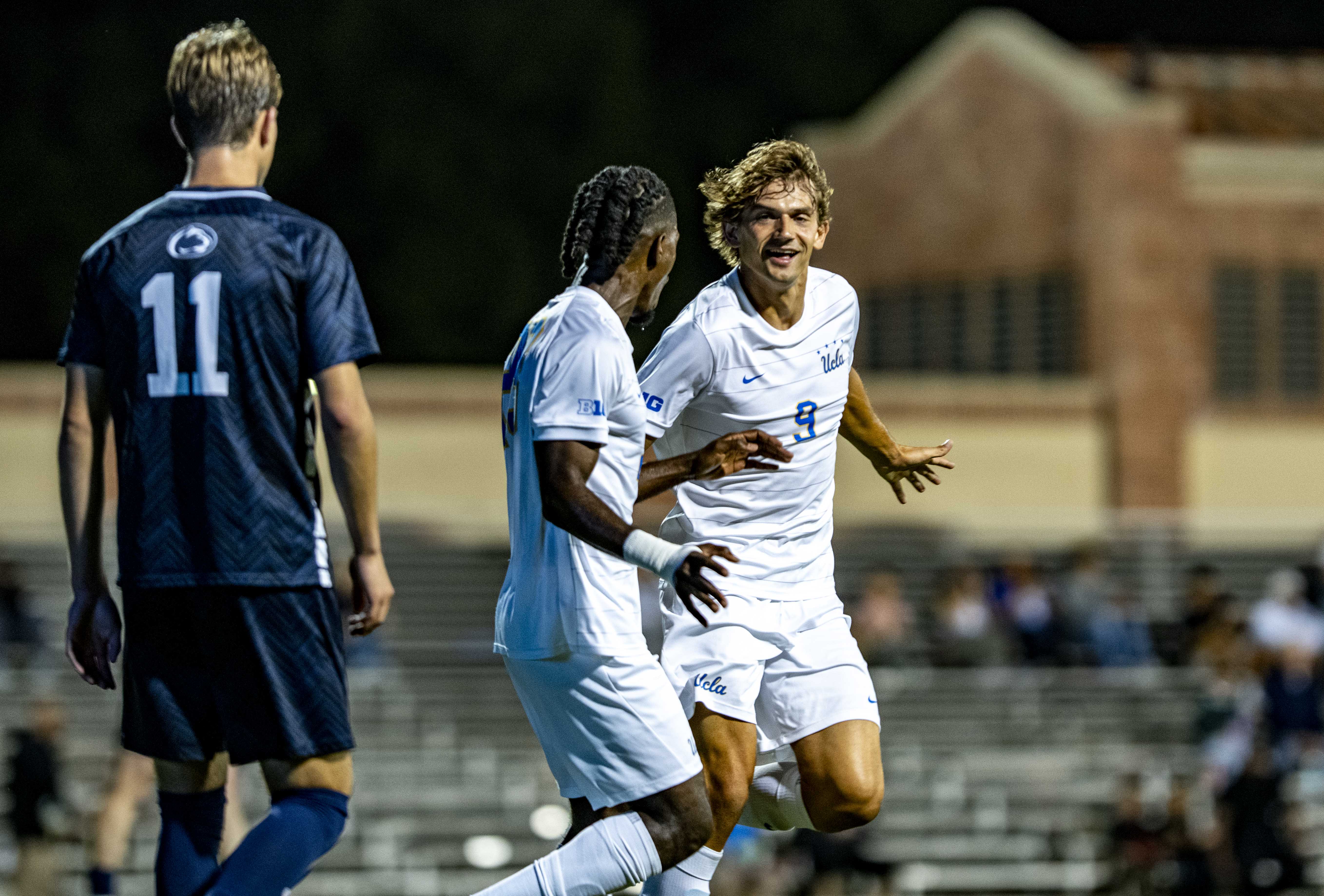 Former UCLA defender Schinieder Mimy (left) and former UCLA forward Sergi Solans Ormo (right) run together past an onlooking Penn State player. Both Mimy and Ormo were selected in the second round of the 2026 MLS SuperDraft. (Libby Li/Daily Bruin)