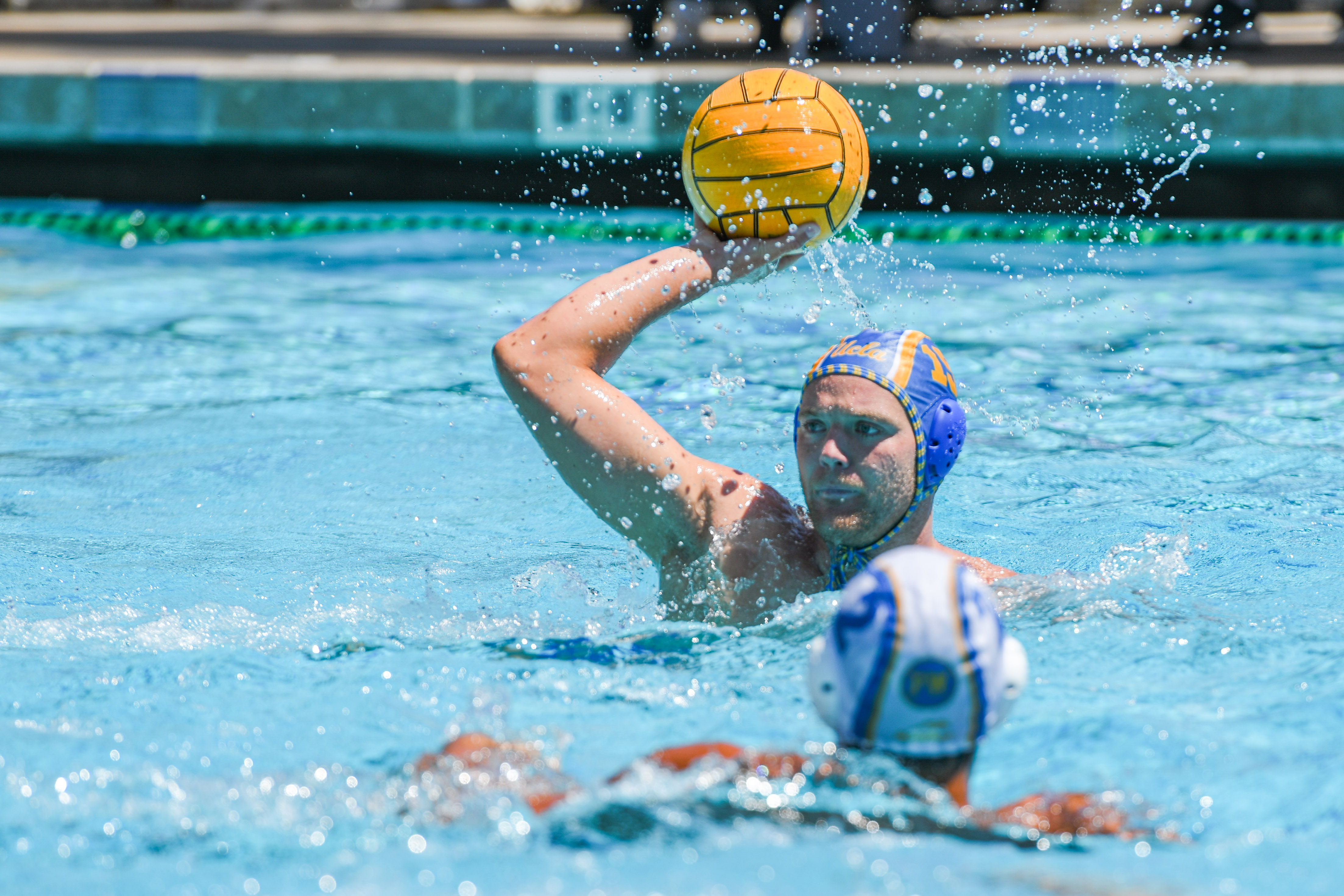 Fifth-year attacker Chase McFarland holds the ball and scans the pool. McFarland is entering his first season with the Bruins after transferring from Stanford. (Amelia Chief/Daily Bruin senior staff)