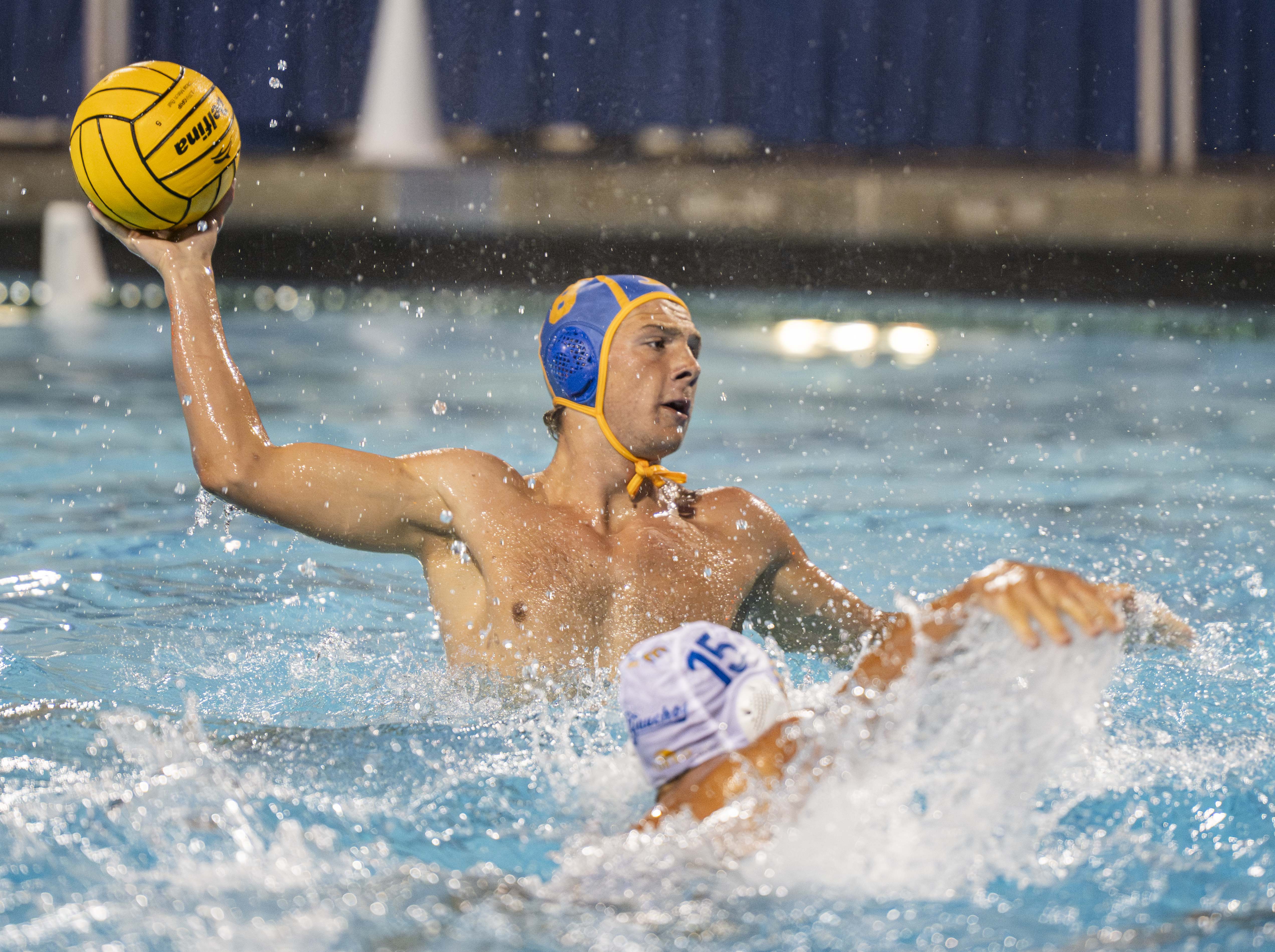 Castillo raises his arm out of the pool to throw the ball. He tallied a season-high seven earned exclusions last season against then-No. 4 Stanford during the MPSF Invitational. (Brianna Carlson/Daily Bruin staff)