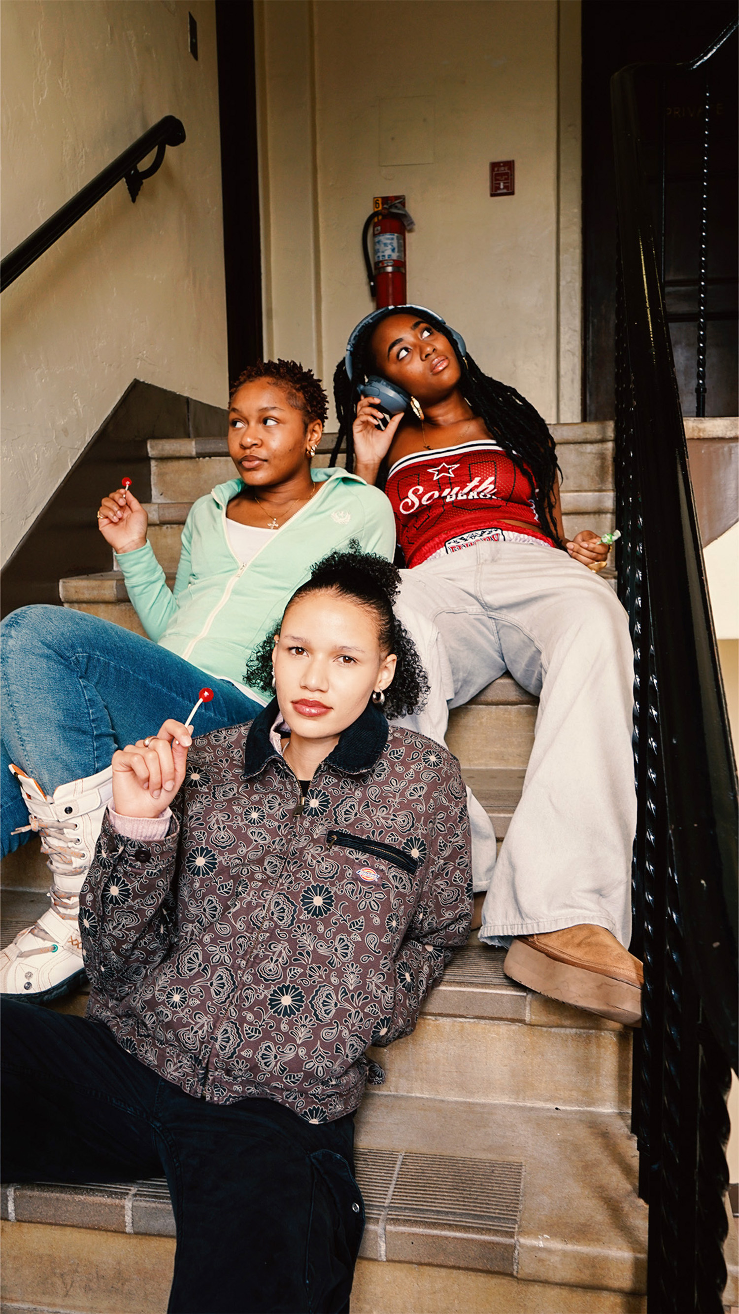 Previous and continuing HHC Directors Audrey, Anna, and Mimi sit on the steps for a photo. While hip-hop remains at the center of the organization, HHC connects members through more than a shared appreciation of the genre, cultivating a space where students can build relationships. (Courtesy of Diego LeComte)