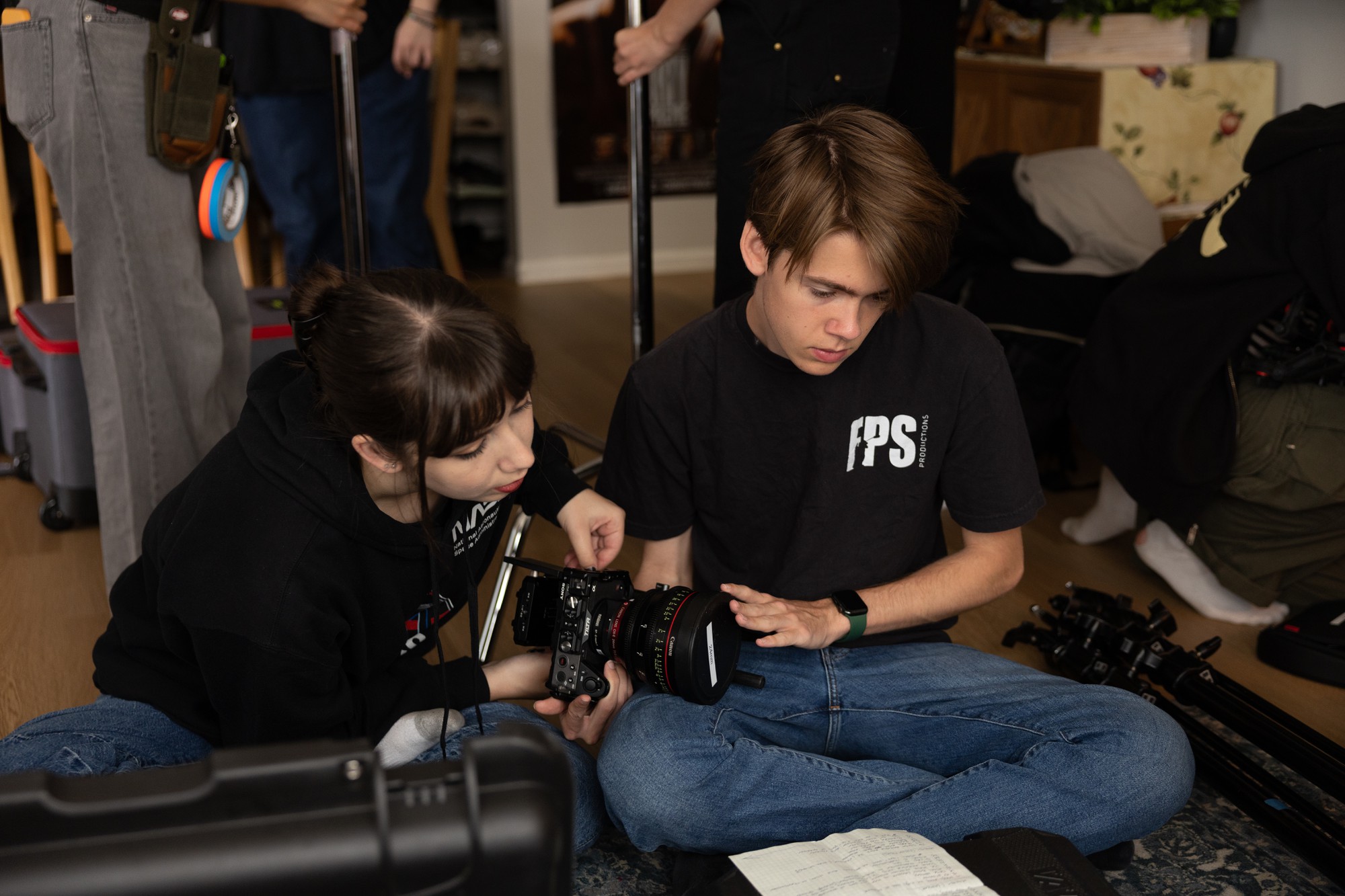 Mathews adjusts a camera while wearing a black shirt. Mathews is researching films with environmental themes with lecturer Alex Franklin. (Courtesy of Kate Mathews)
