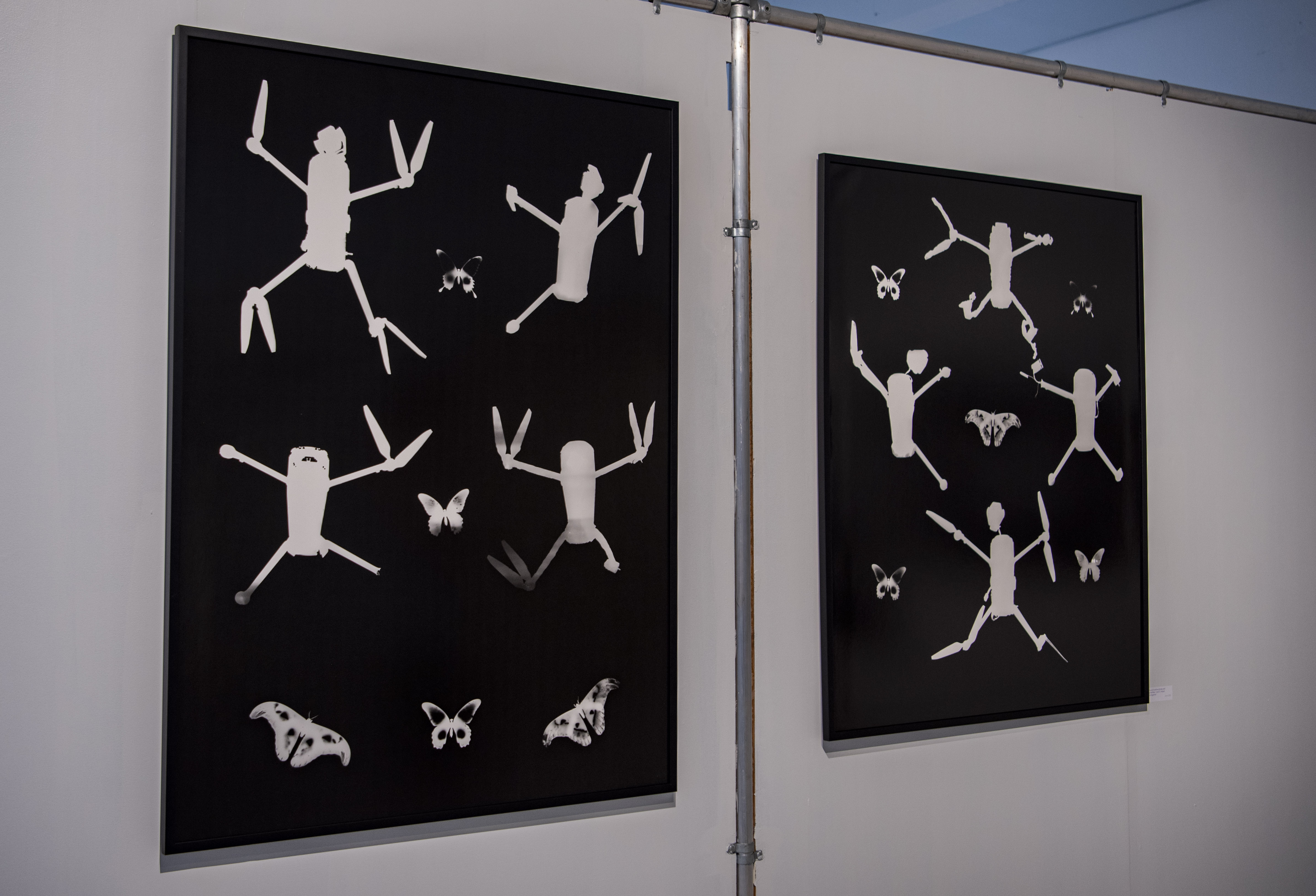A photo showcases butterflies juxtaposed with drones. Neville said now is an extremely critical time for Ukraine, with explosions happening almost every day, reminding him why the exhibition feels so urgent. (Crystal Tompkins/Daily Bruin senior staff)