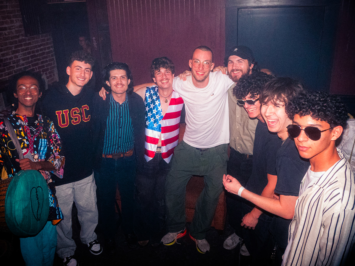 The second-year student and other musicians stand around smiling into the camera. Persona non grata's upcoming album “Cowabunga” treats different music styles with integrity as Cragen learns the social and political contexts behind the sounds inspiring his own work. (Courtesy of Anthony Perez)