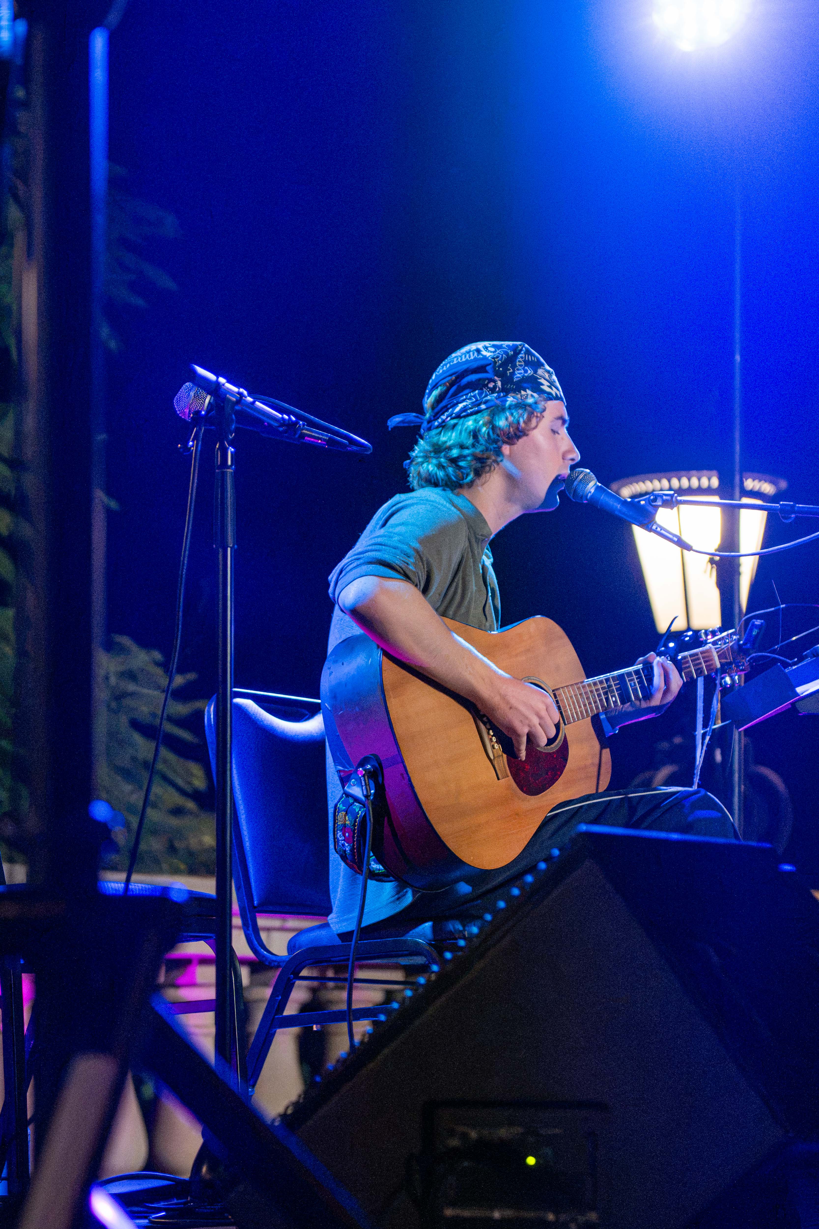 Nico Brouwer strums a guitar while singing. During his solo set, he performed songs like “Long Hair, Smooth Child” and “Lizard Tail.” (Presley Liu/Daily Bruin senior staff)