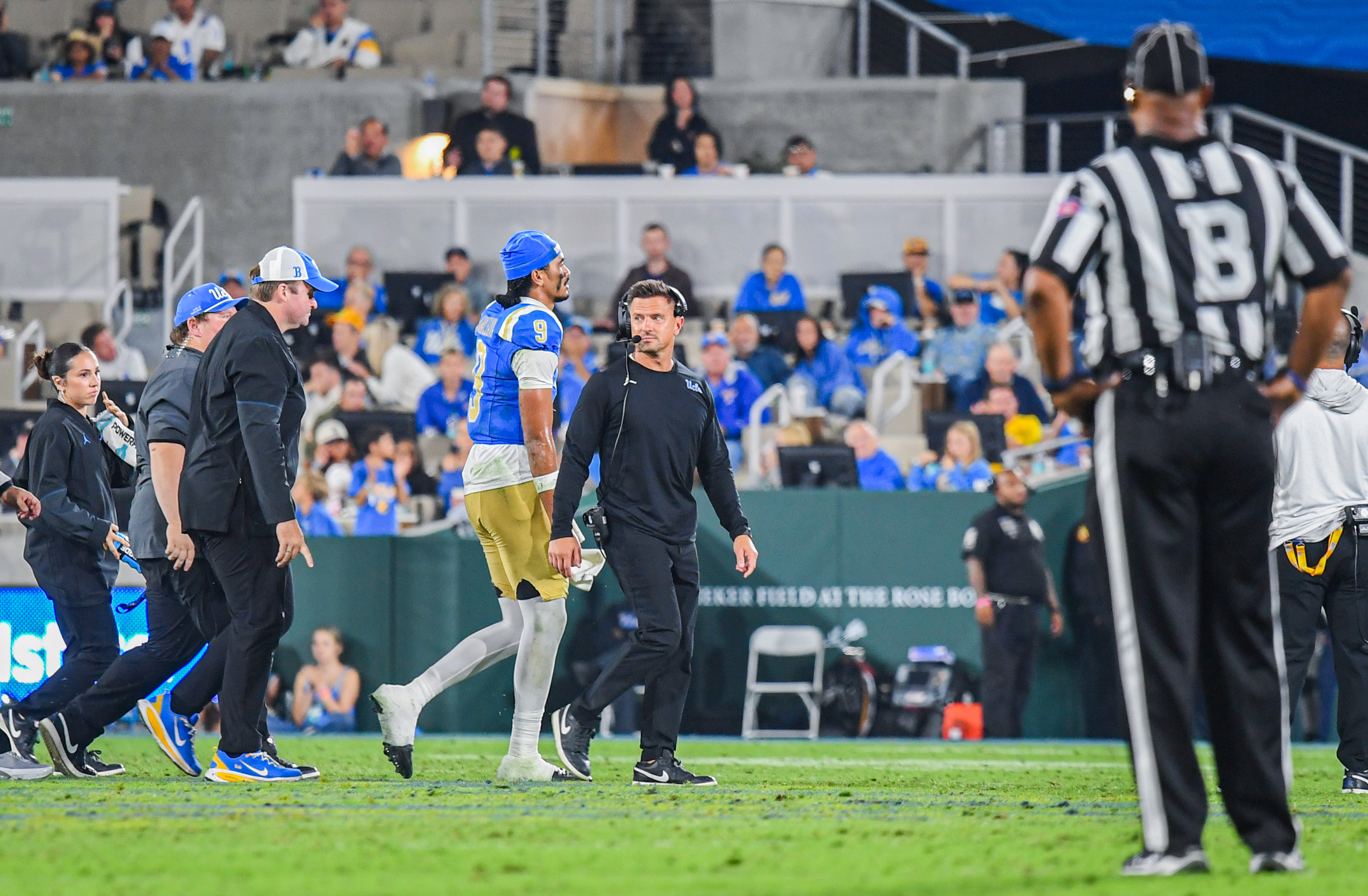 Senior quarterback Nico Iamaleava walks off the field in the middle of a drive with coach Bob Chesney. (Kai Dizon/Assistant Photo editor)